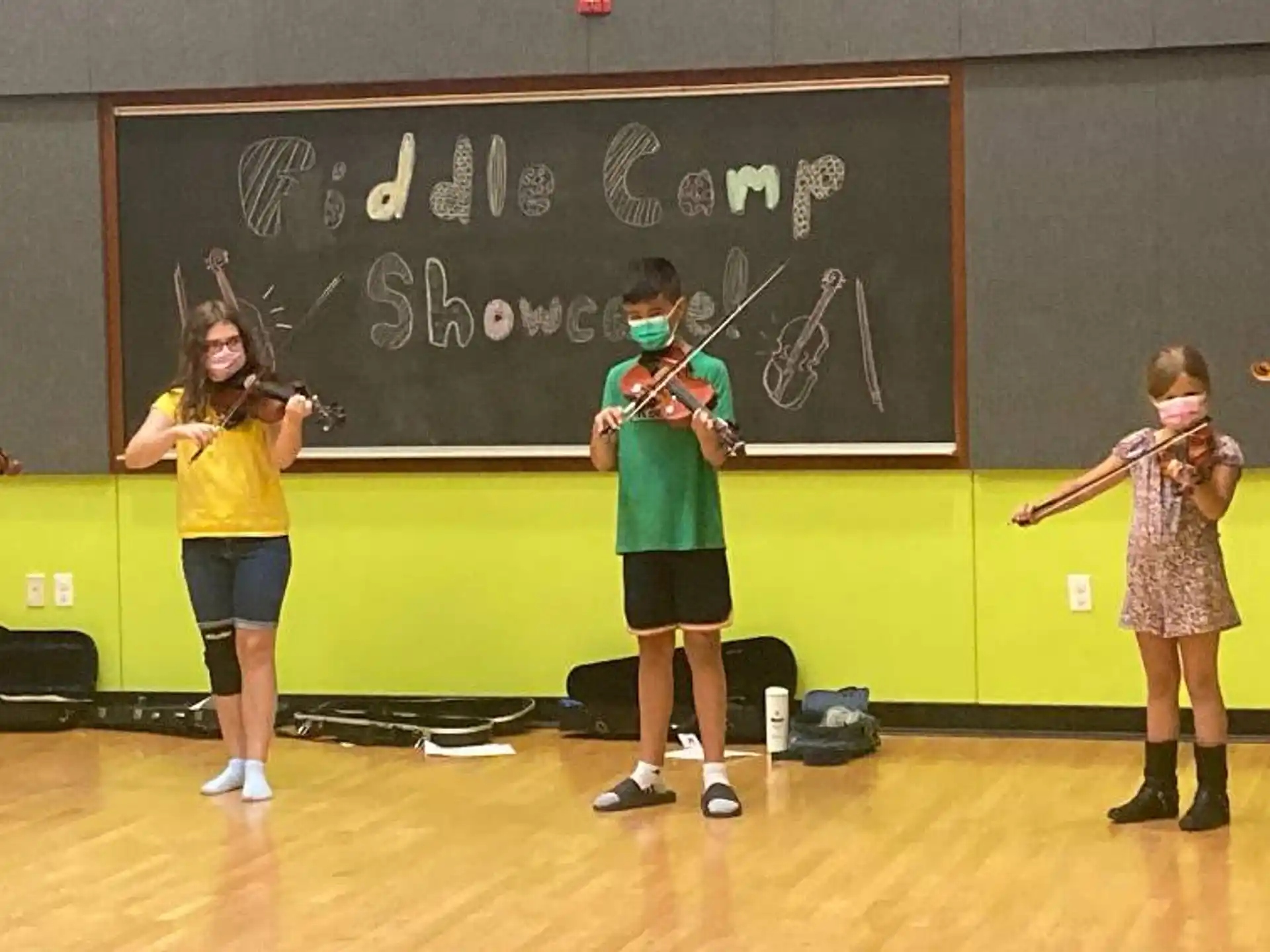a group of children playing violin