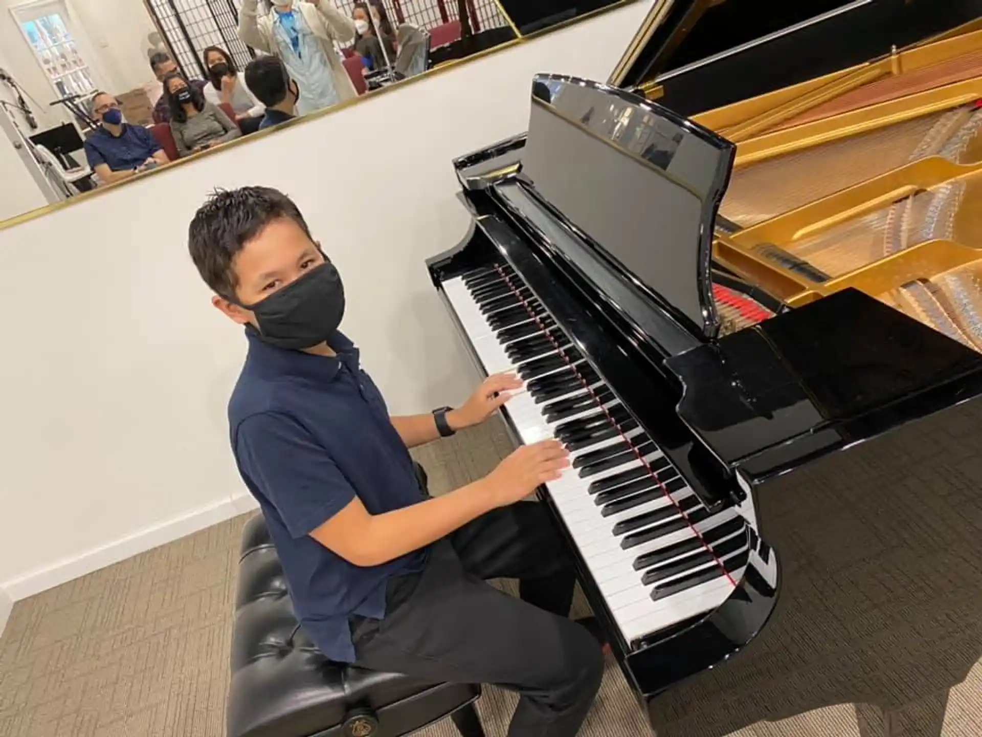 a boy playing a piano