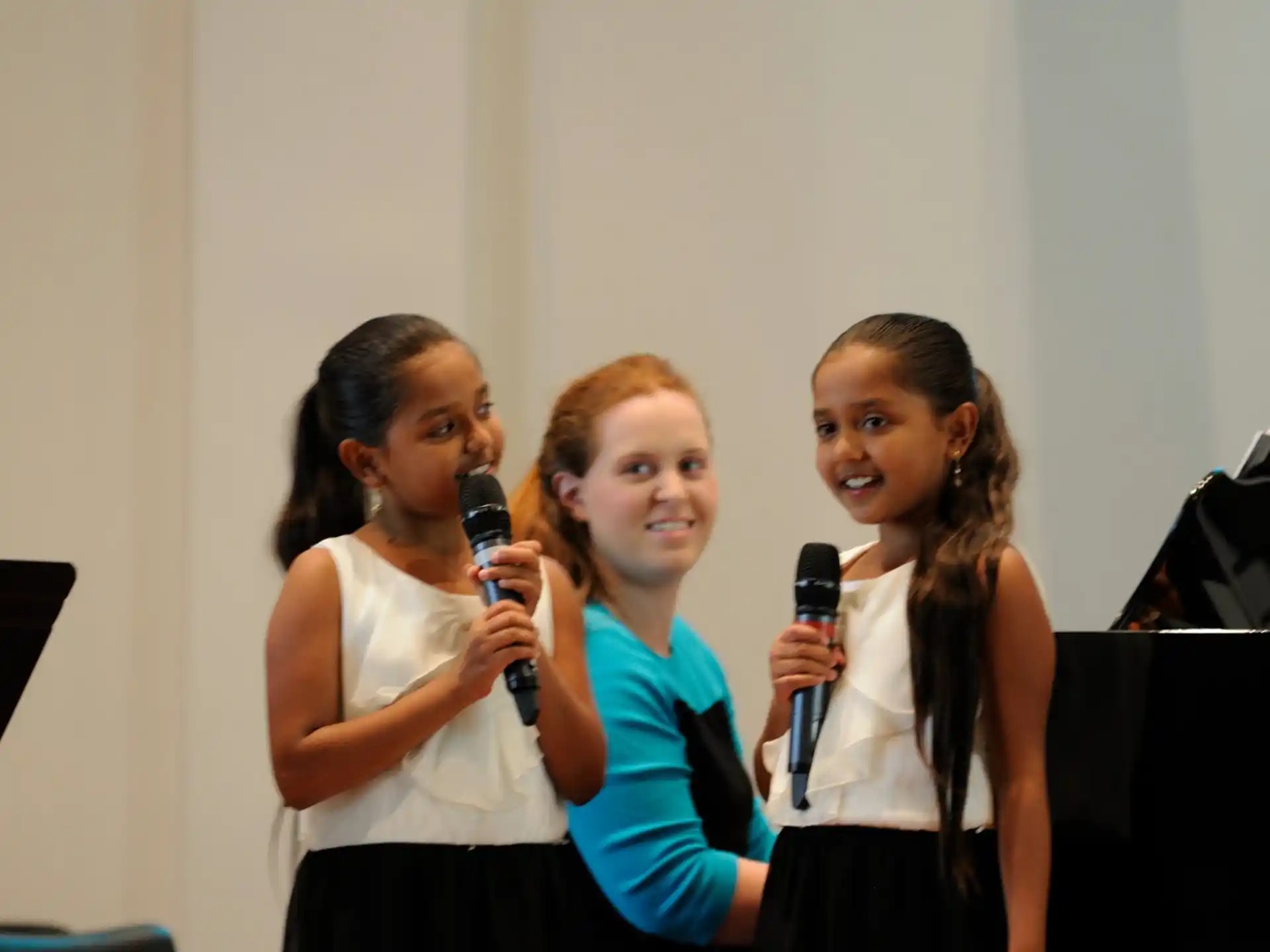 a group of women holding a microphone