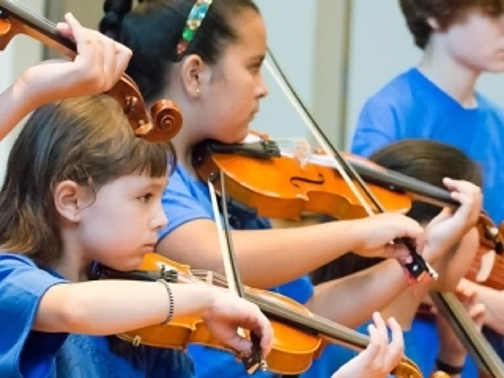 a group of kids playing violin