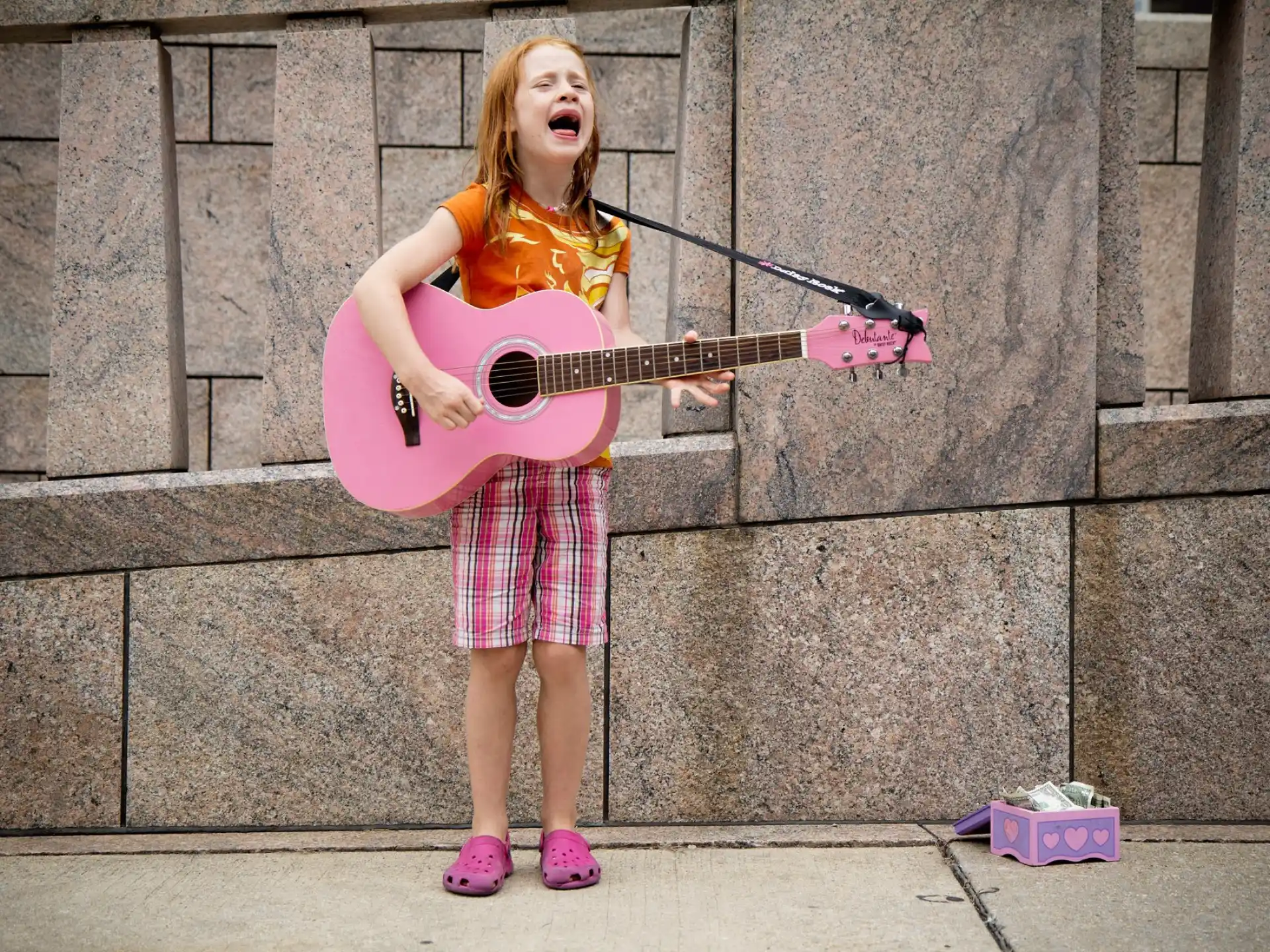 a girl playing a guitar
