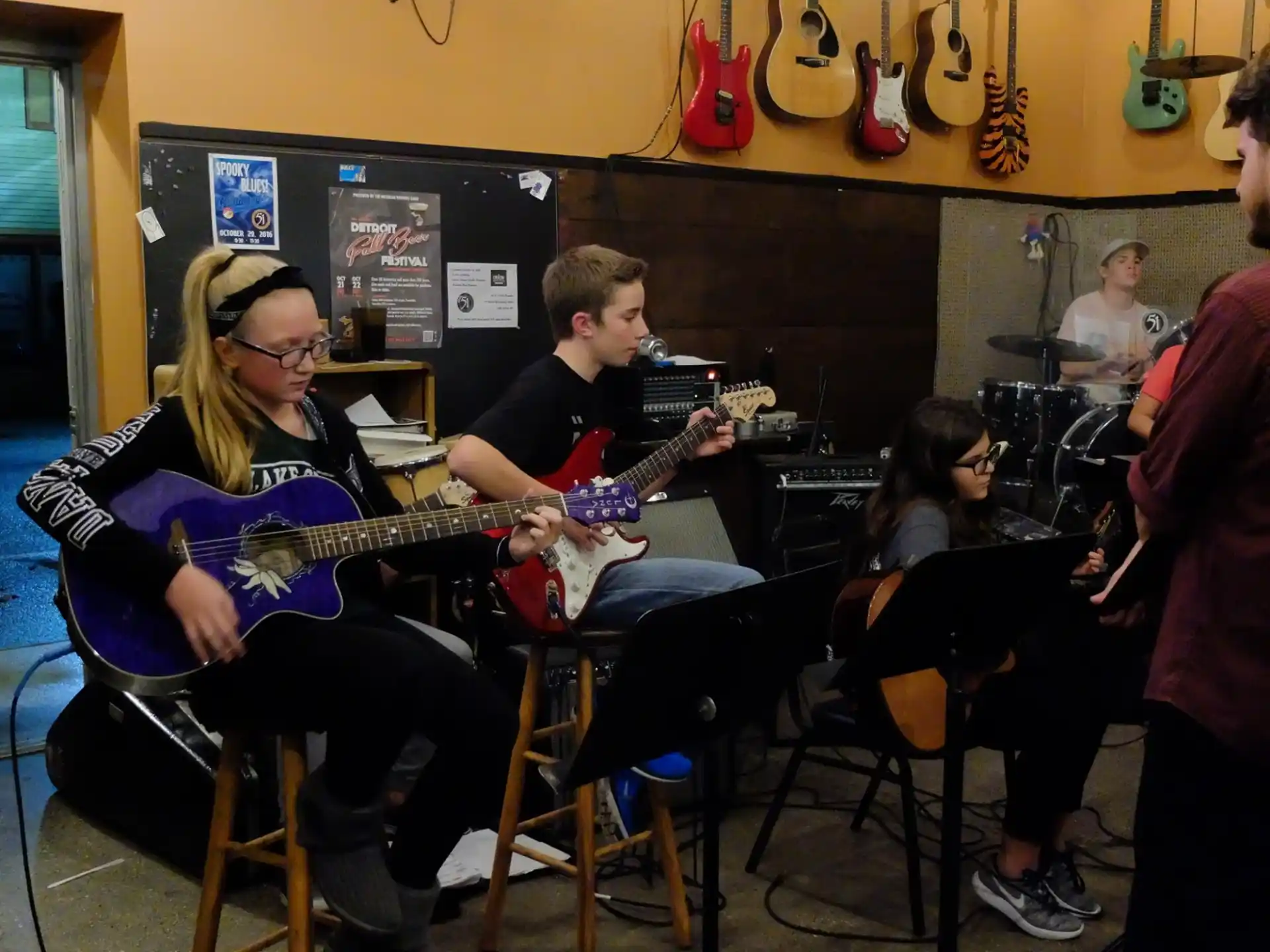 a group of people playing guitars