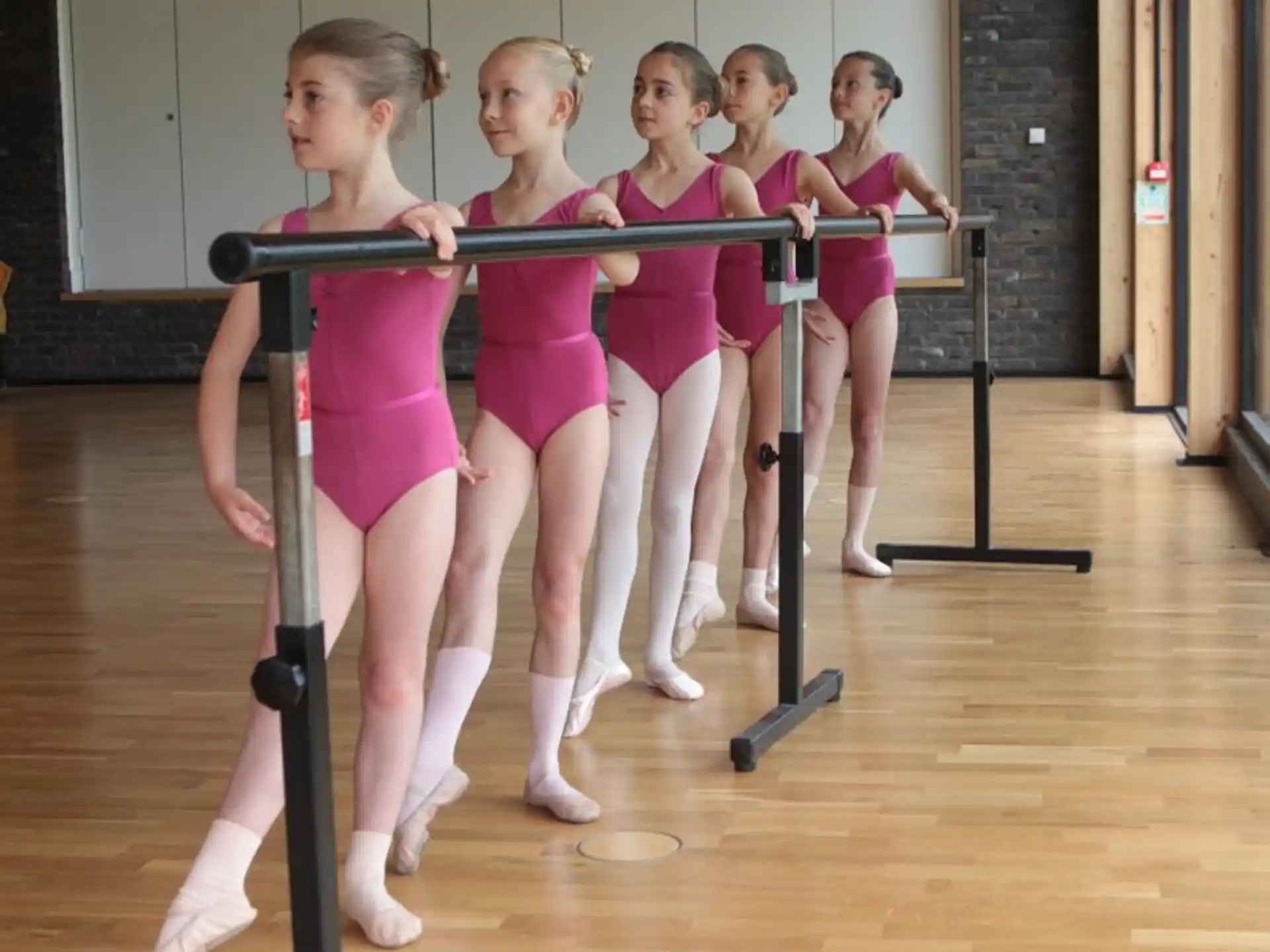 a group of girls in pink uniforms