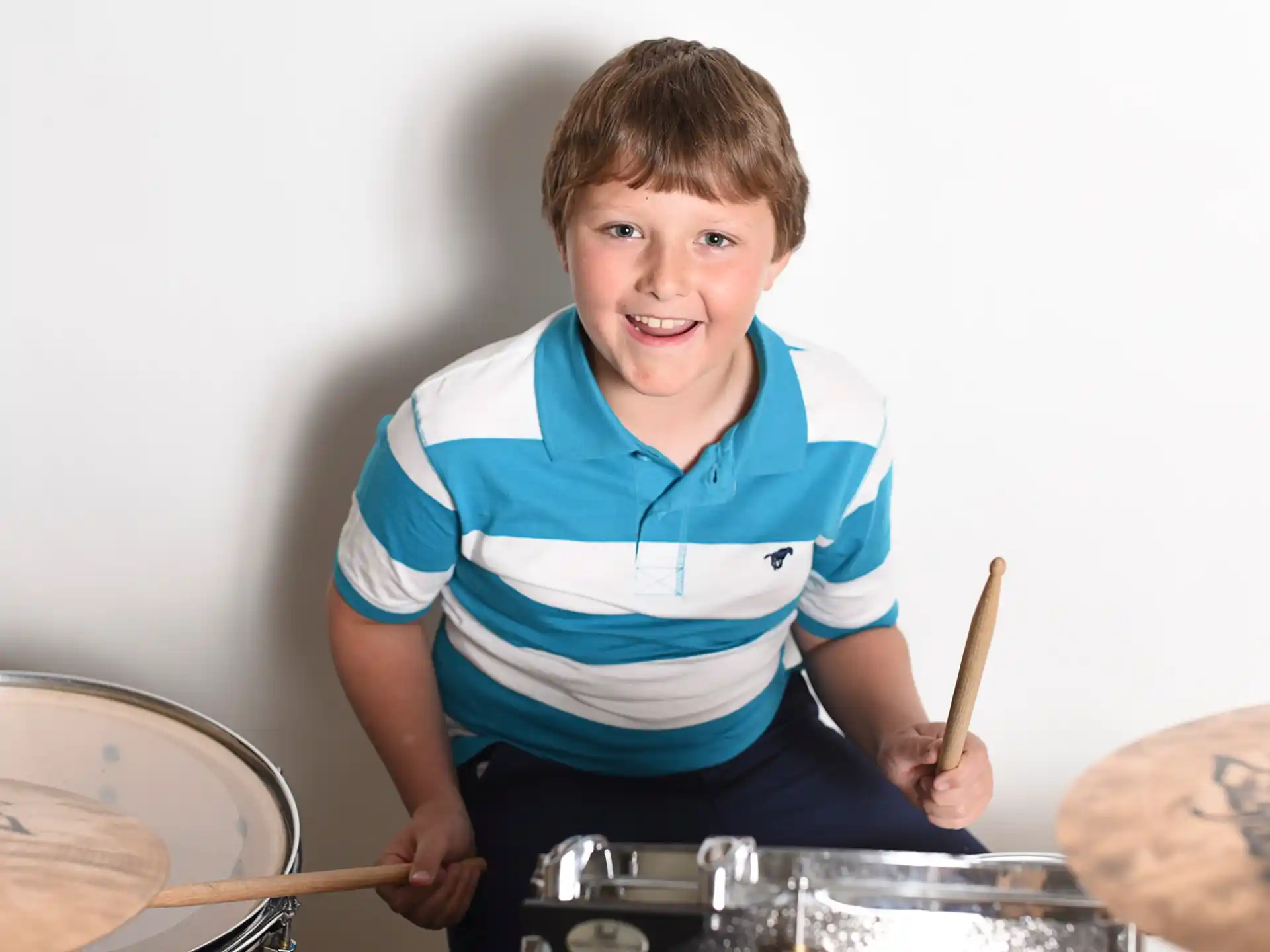 a boy playing drums