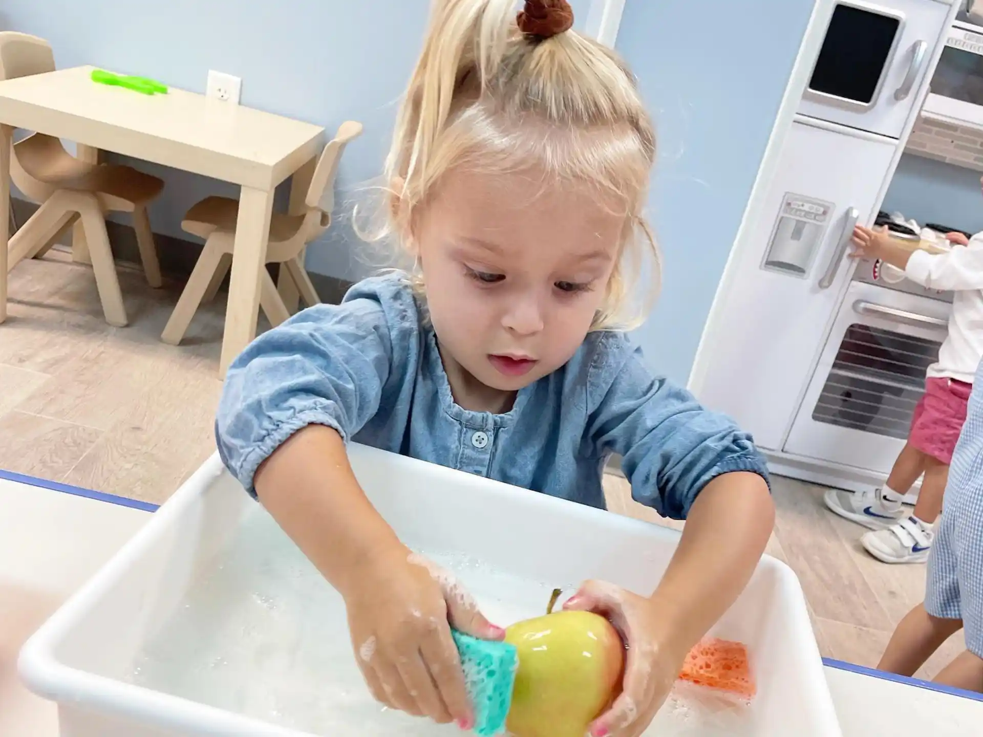 a little girl playing with a toy