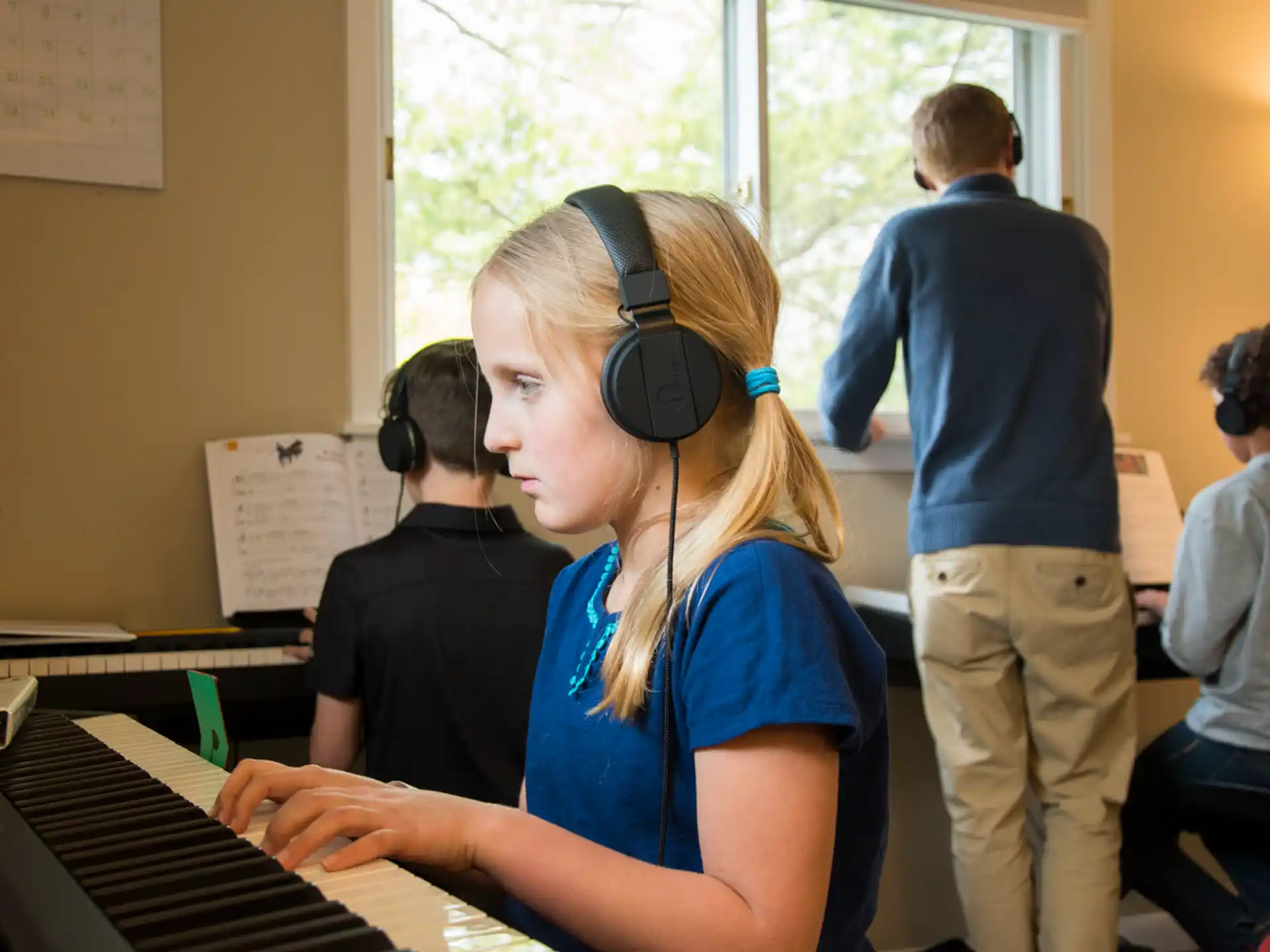 a person wearing headphones and playing a piano