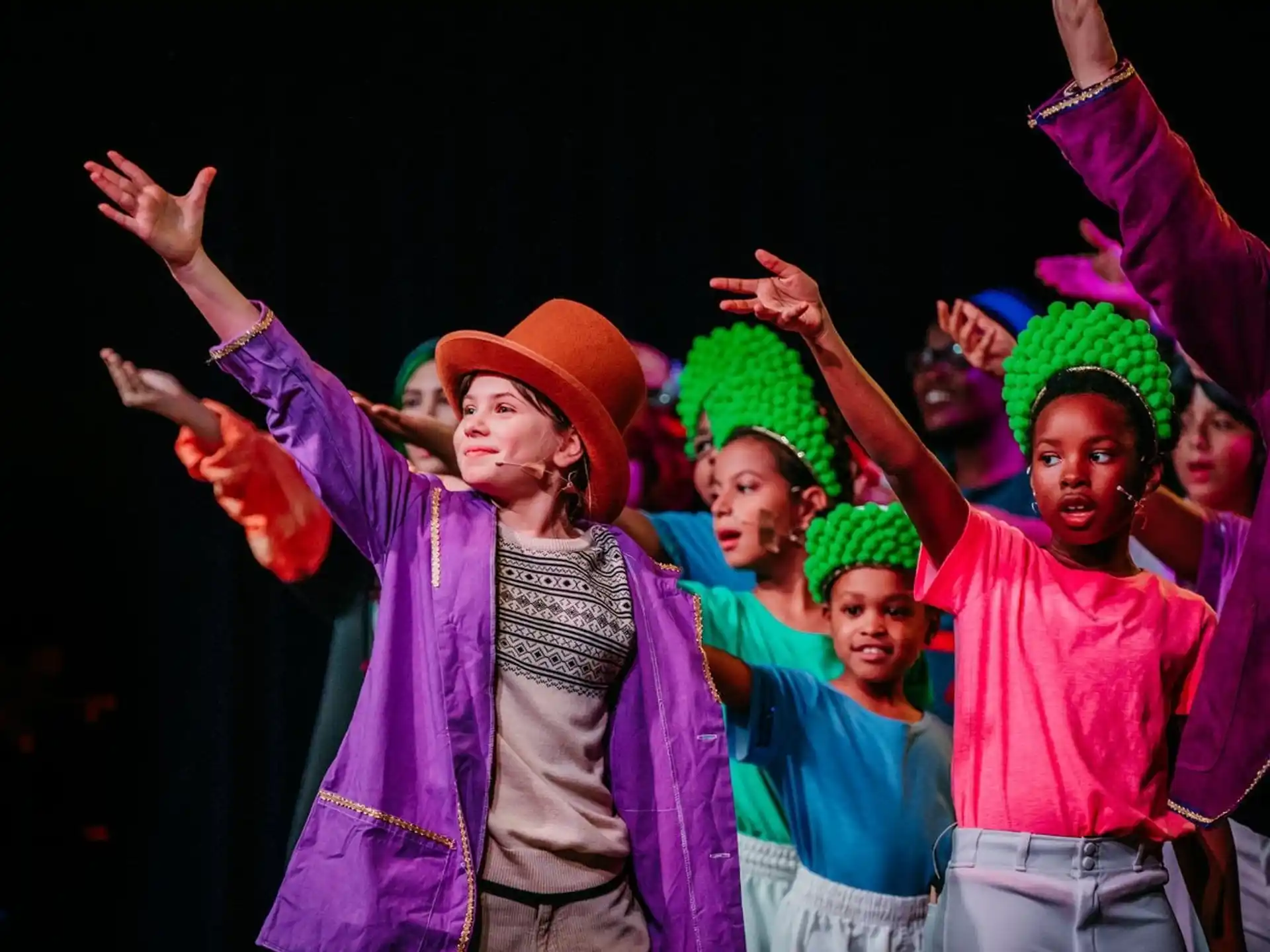 a group of people wearing colorful hats