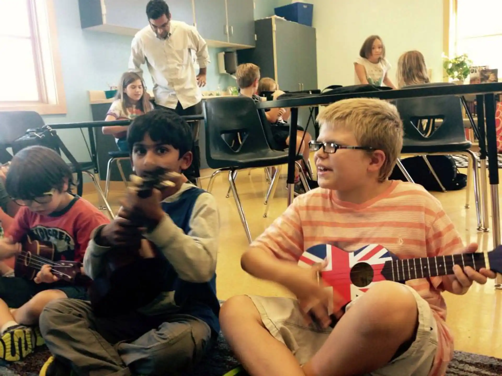 a group of children sitting in chairs