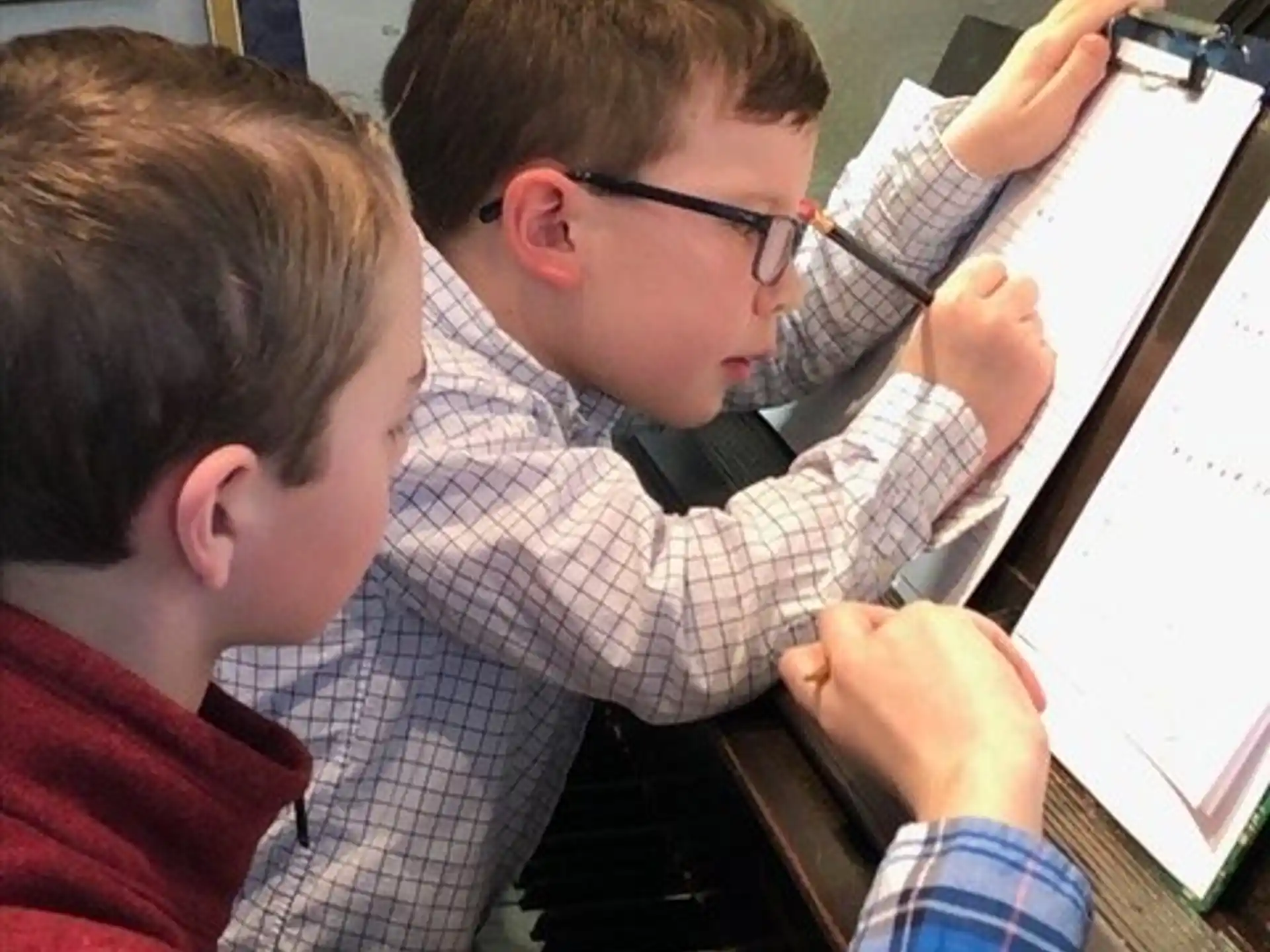 a group of boys playing piano