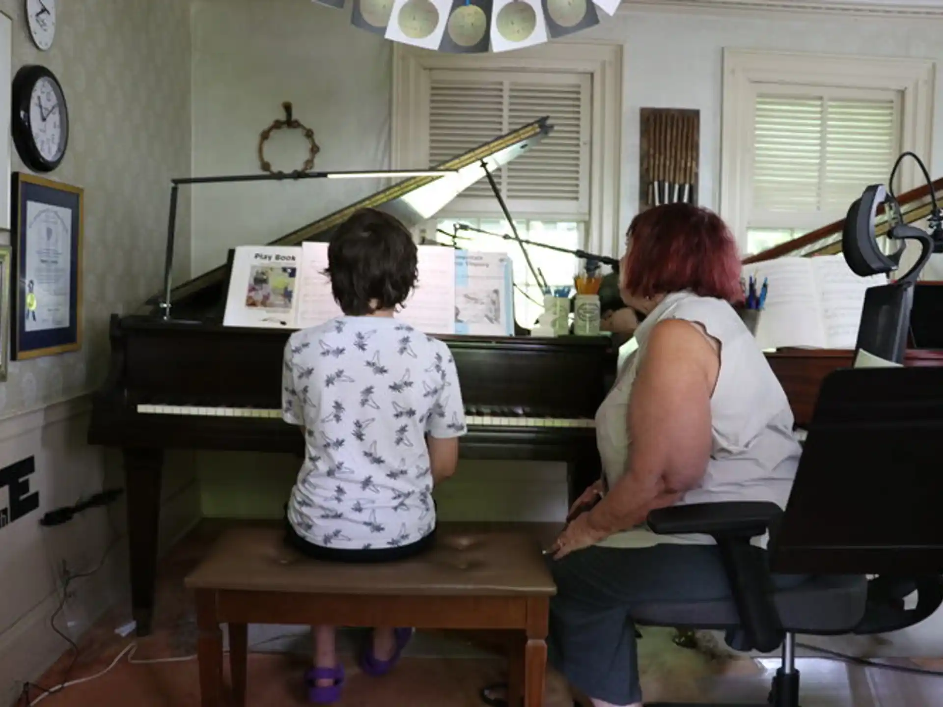 a person and a child playing piano