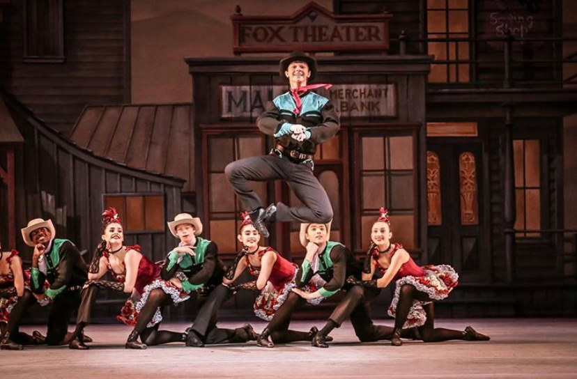 a person jumping in the air with a group of people around him