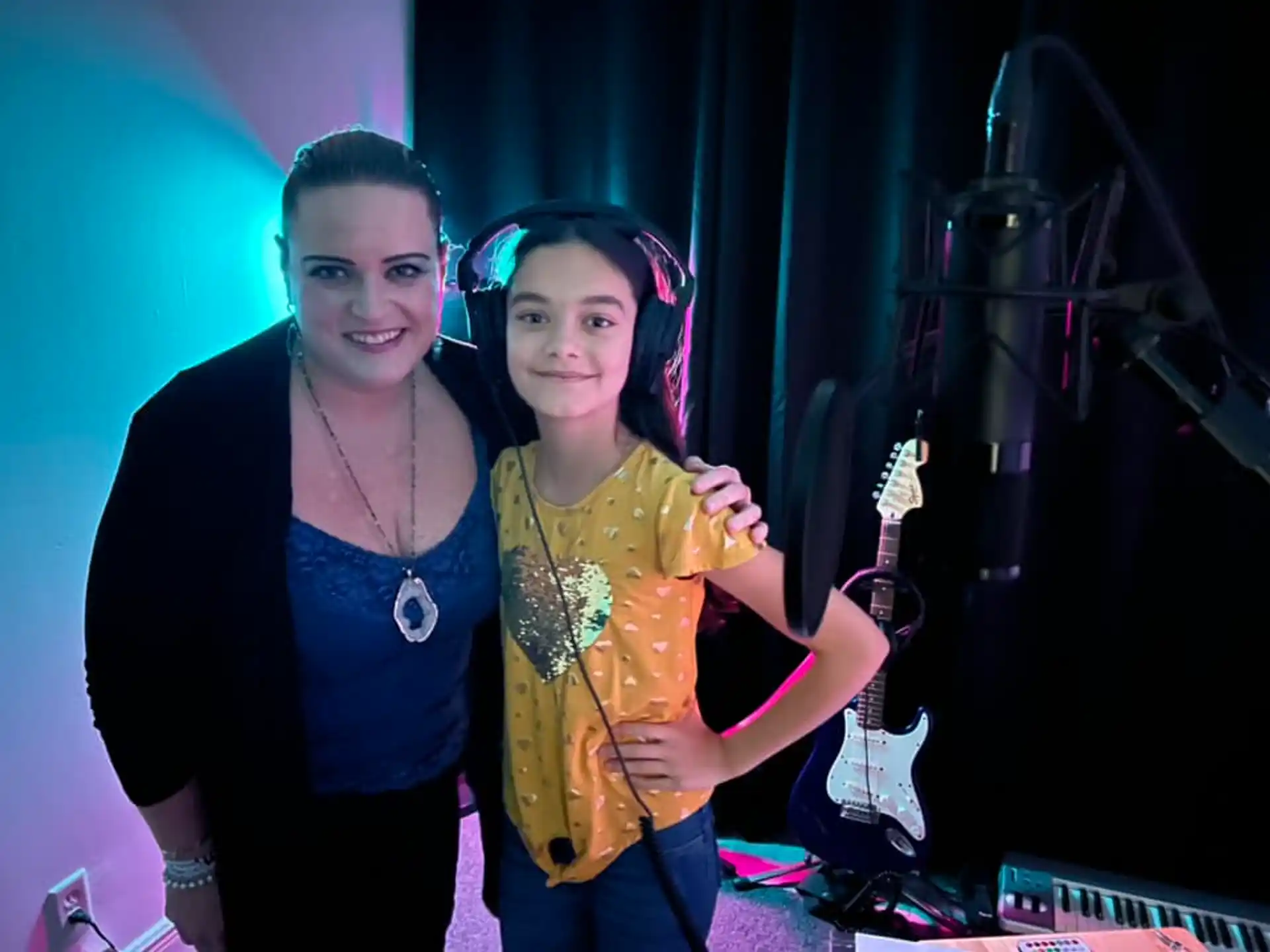 a woman and a girl posing for a picture