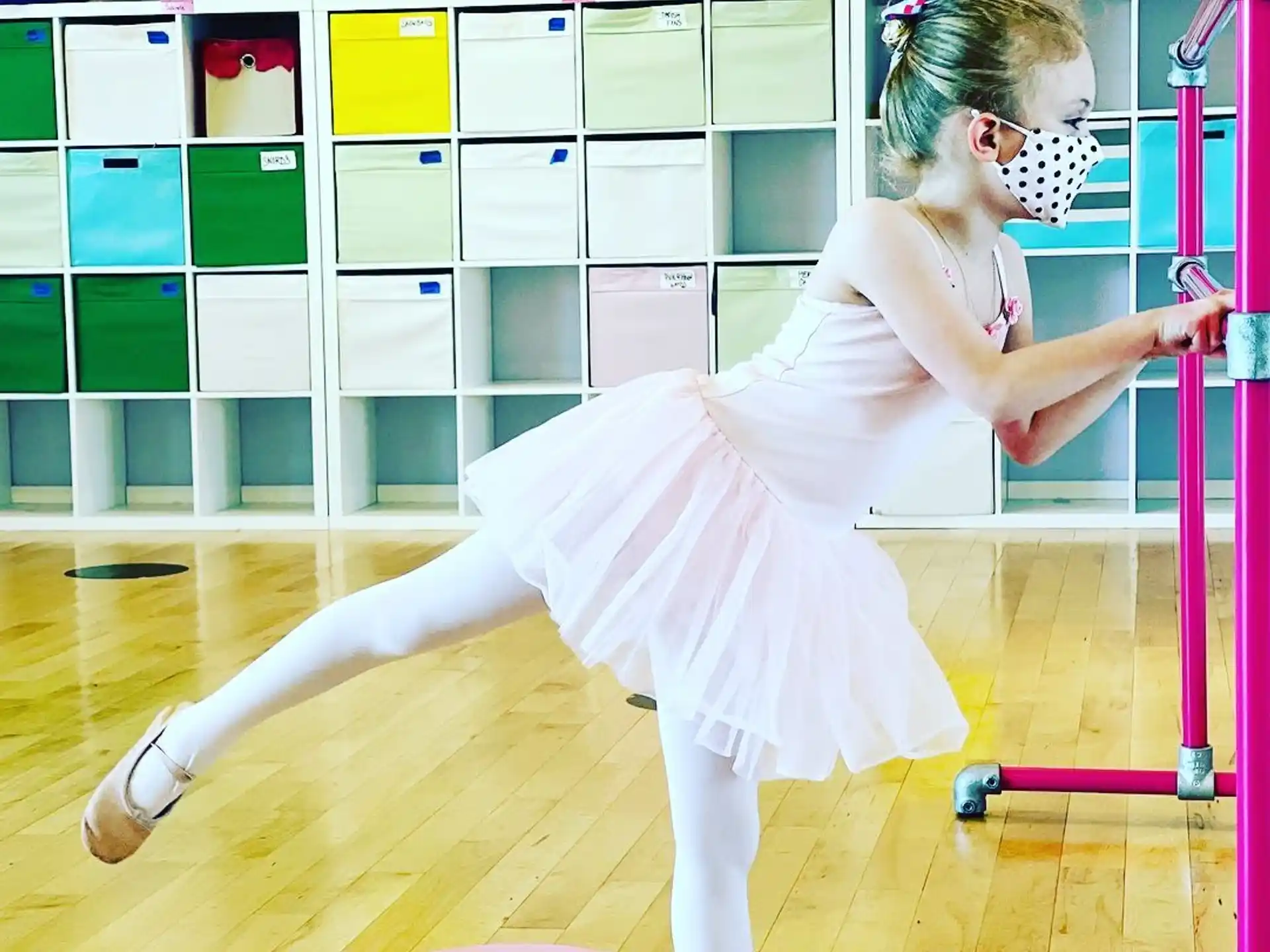 a woman in a white dress doing a plank on a gym floor