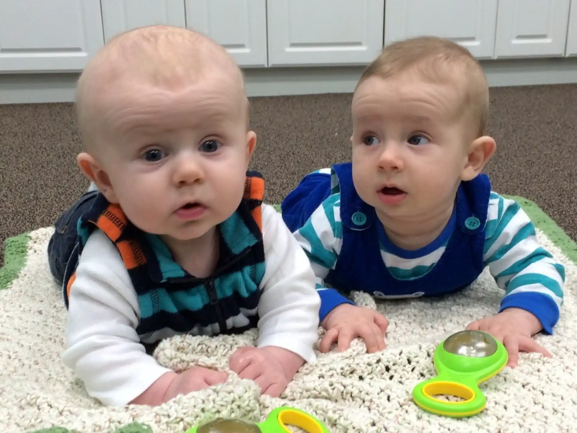 two babies sitting on the floor