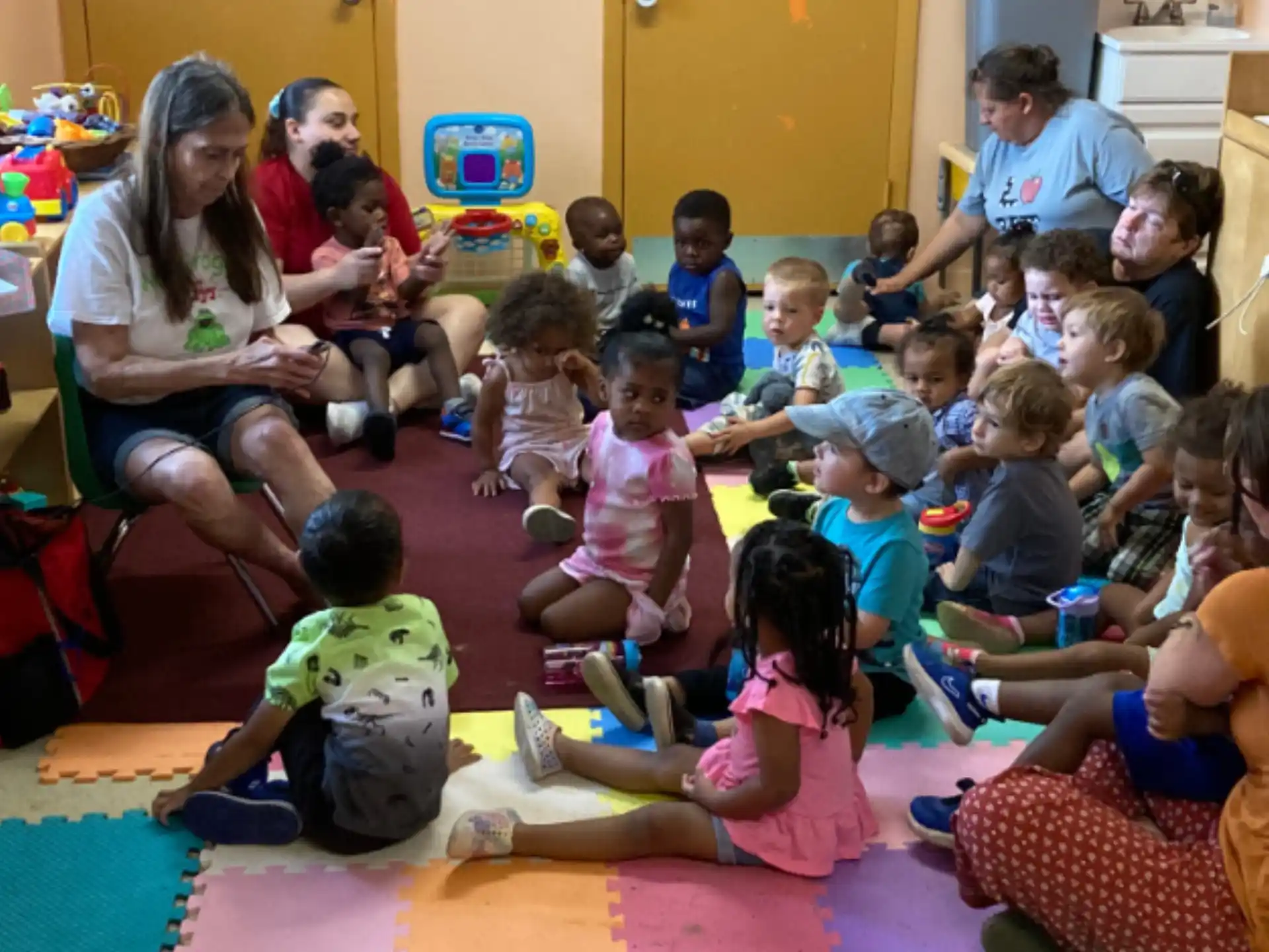 a group of children sitting on the floor