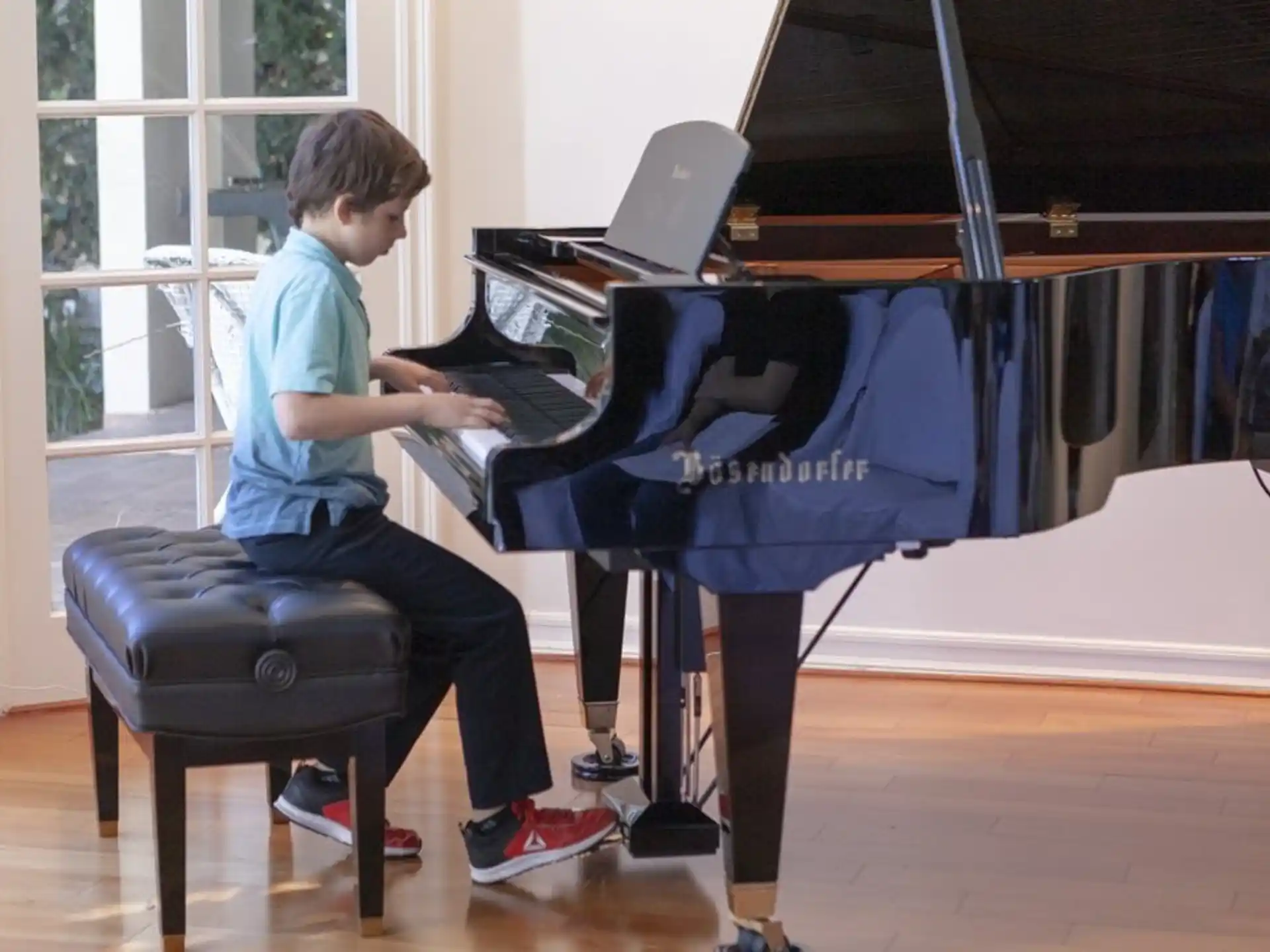 a boy playing a piano
