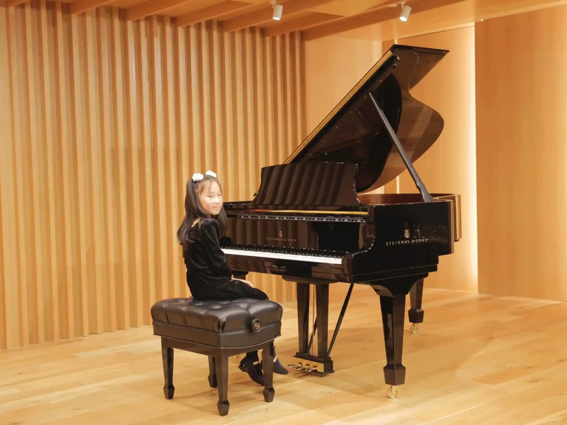 a person sitting at a piano