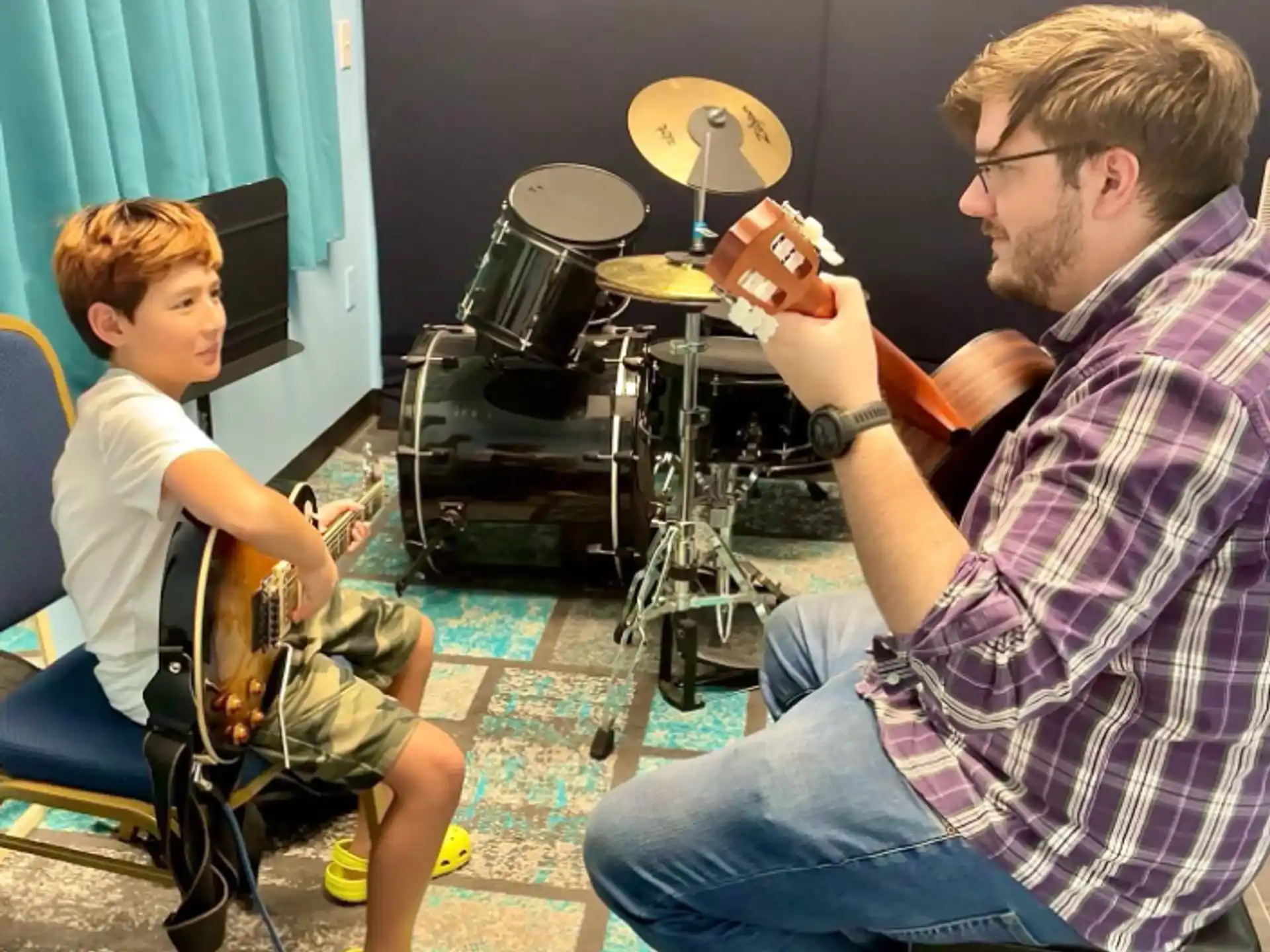 a man and a boy playing a video game