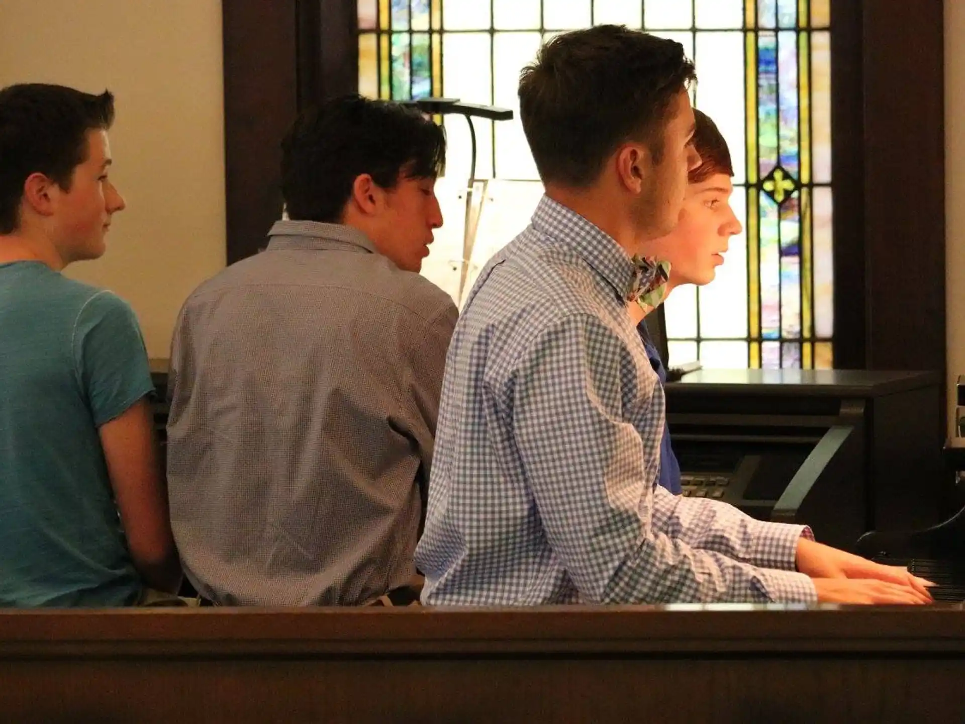 a group of men sitting at a desk