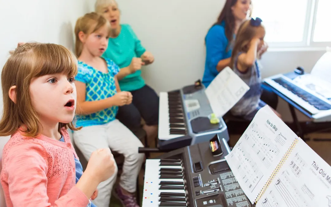 a group of children playing a piano