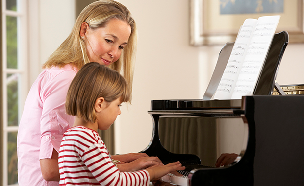 a woman and a child looking at a computer
