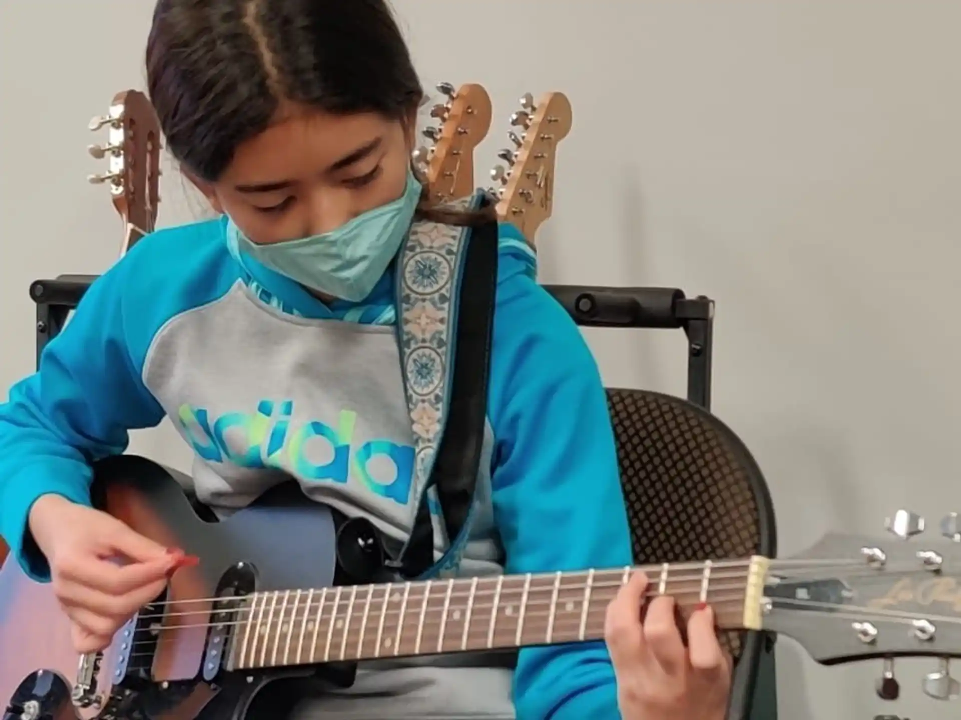 a boy playing a guitar