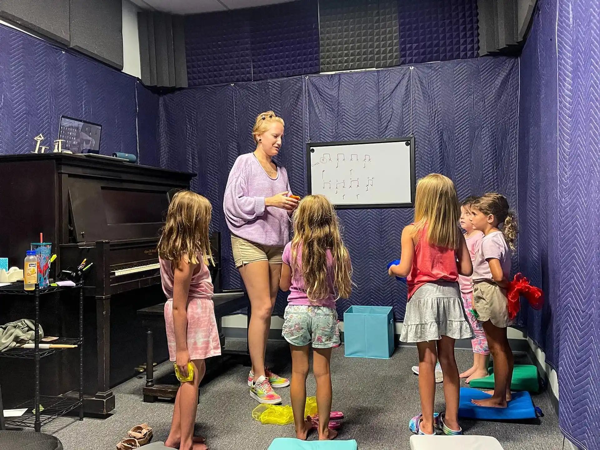 a person and several children standing in front of a screen