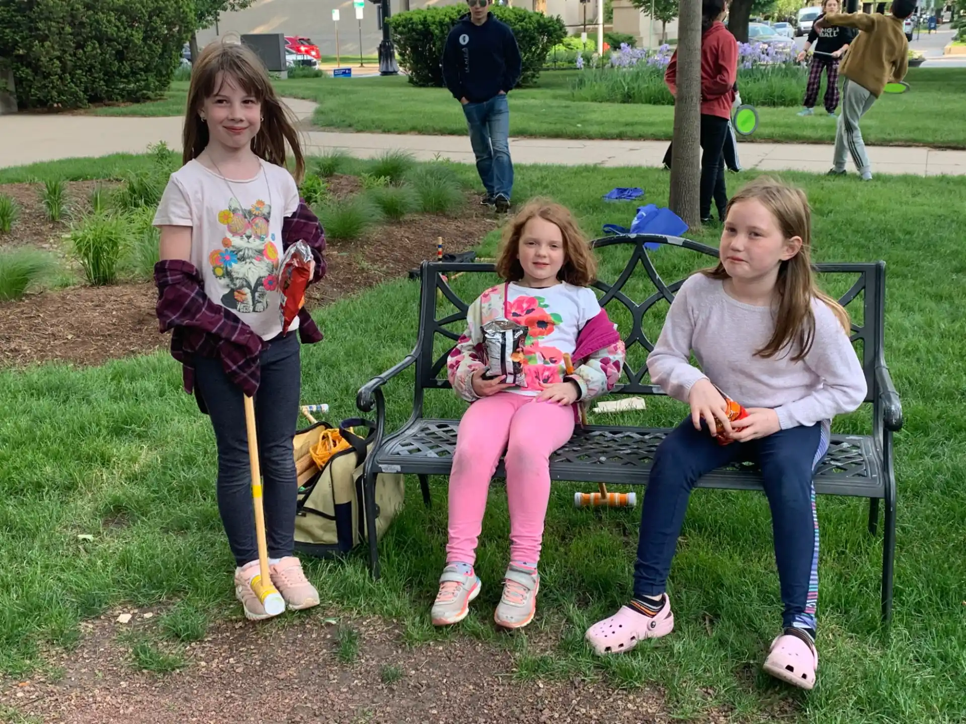 a group of girls sitting on a bench