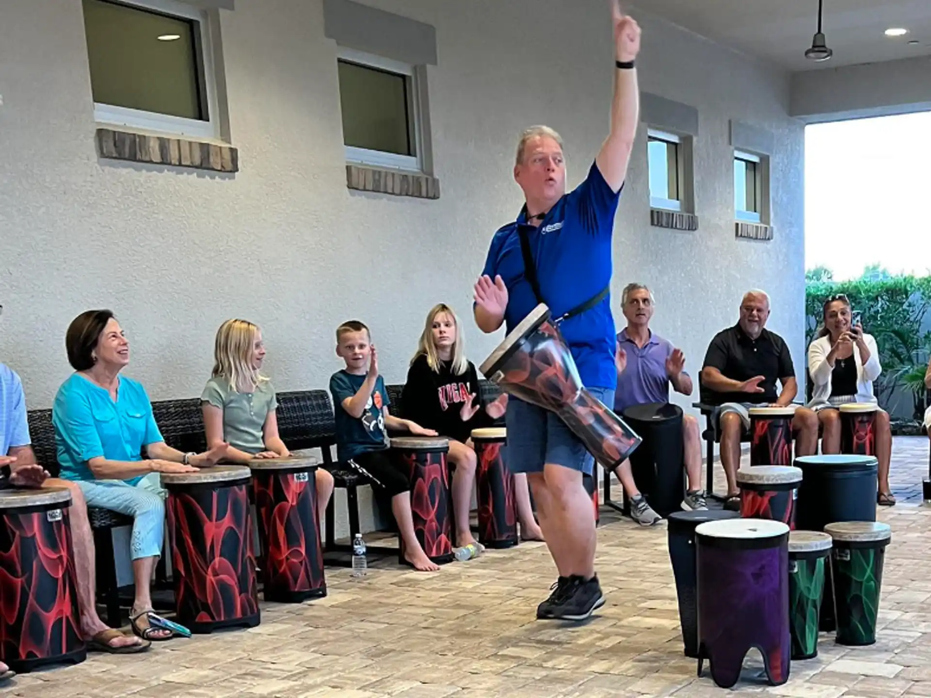 a person holding a book in front of a group of people