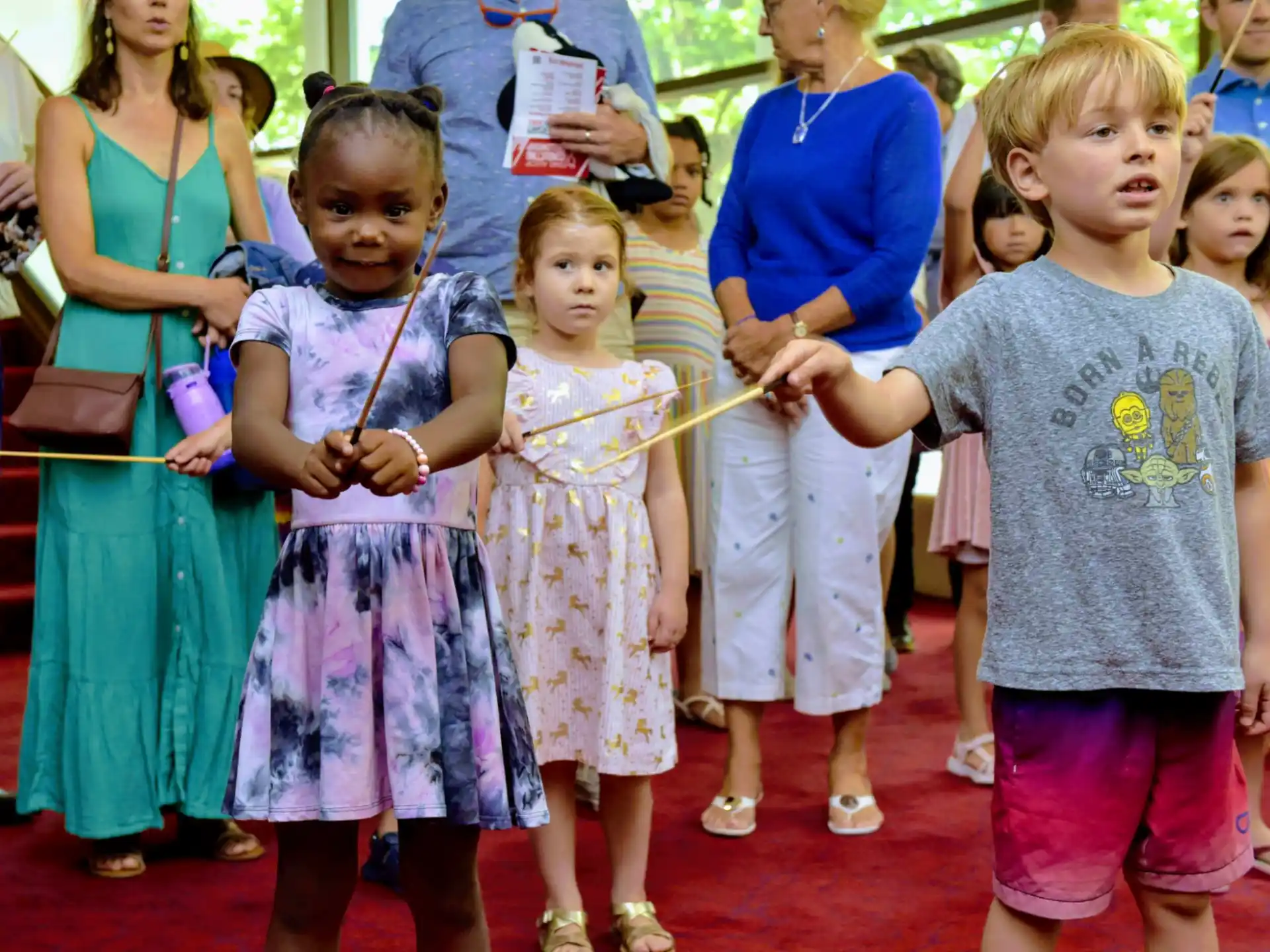 a group of children holding a ribbon