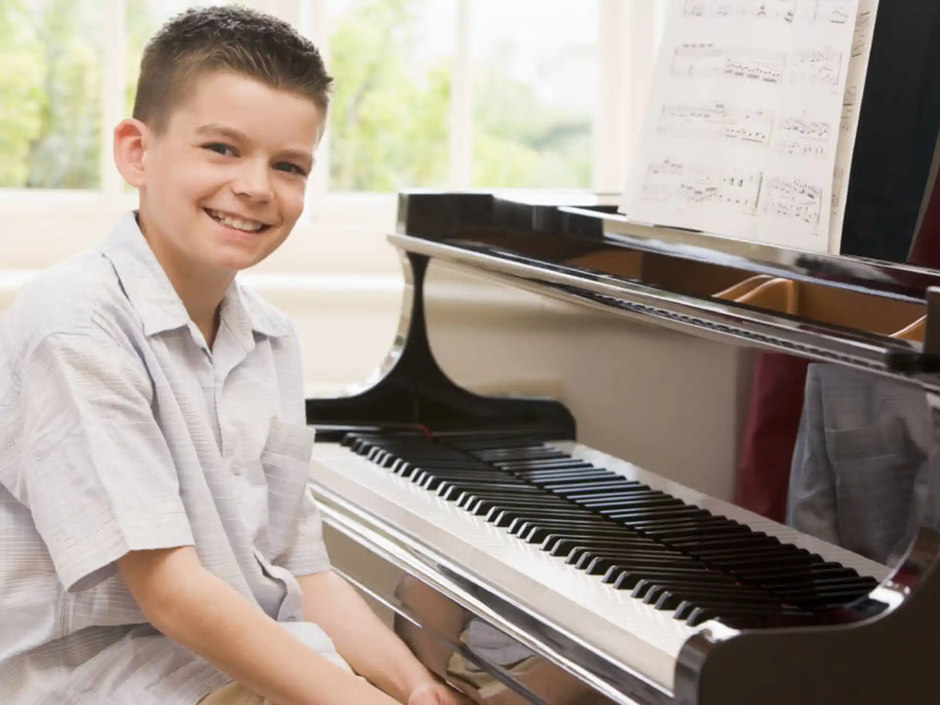 a boy playing a piano