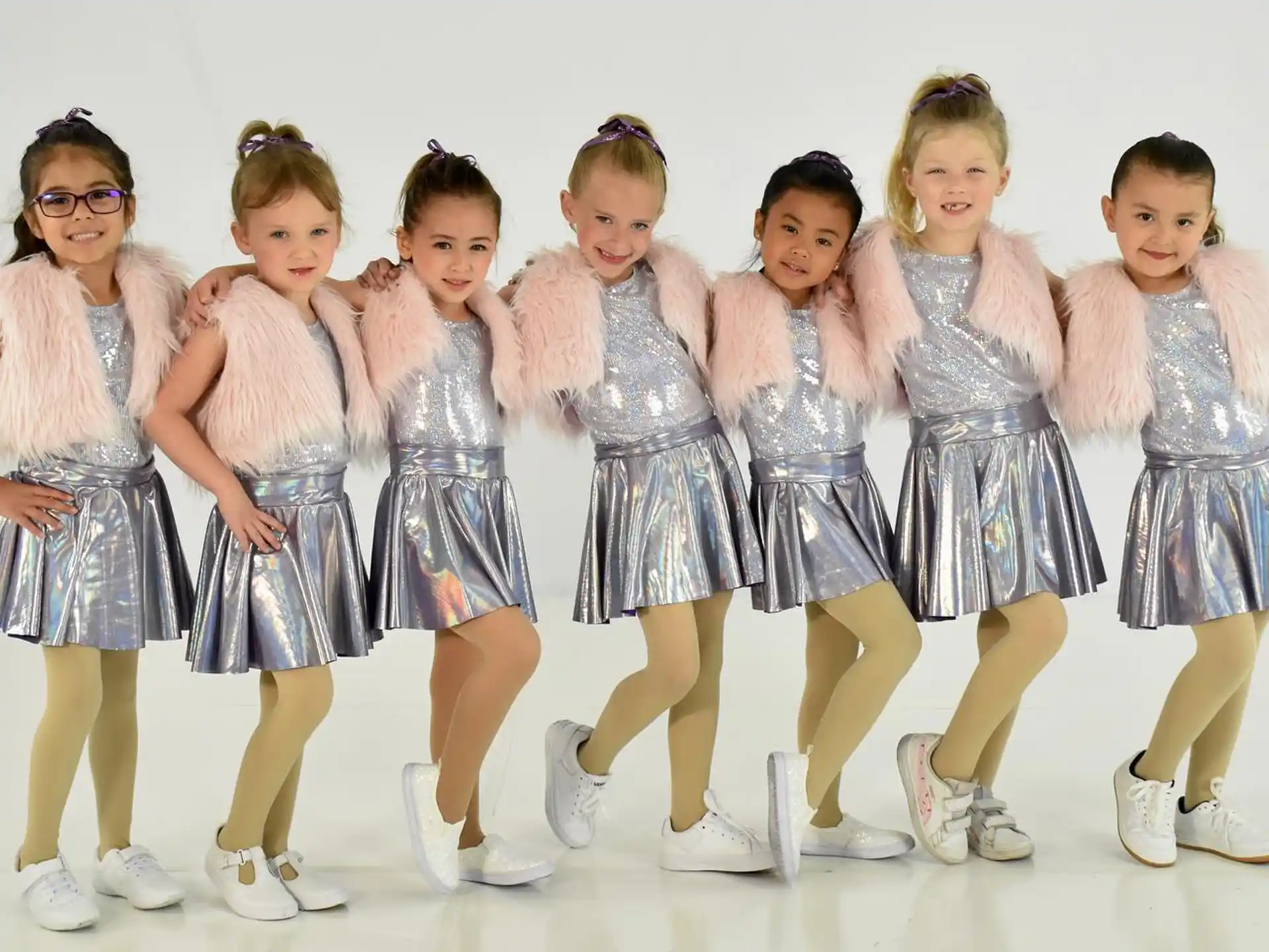 a group of girls in dresses