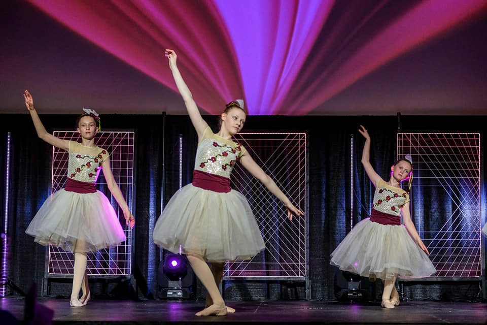 a group of women dancing on a stage