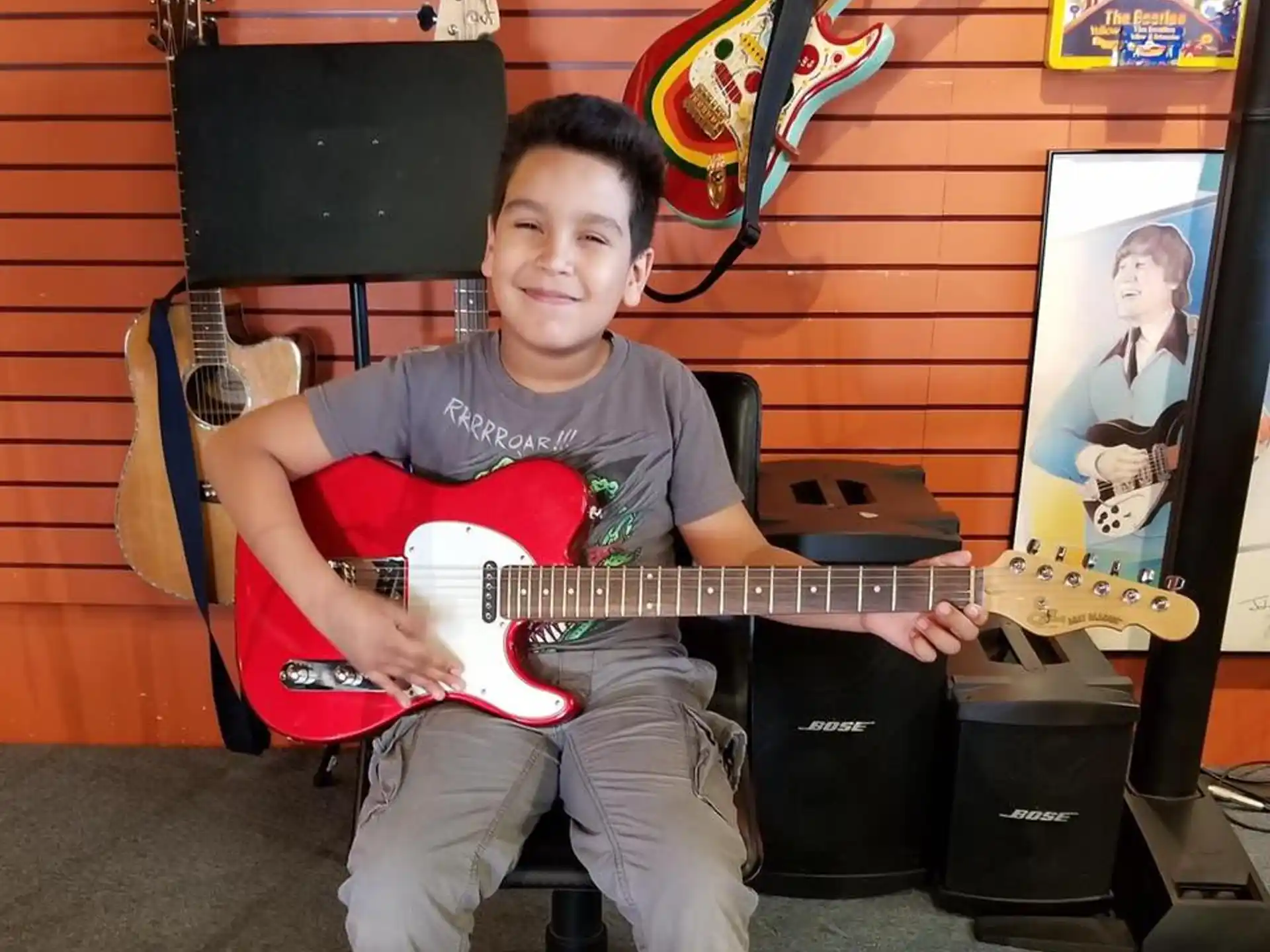 a boy holding a guitar