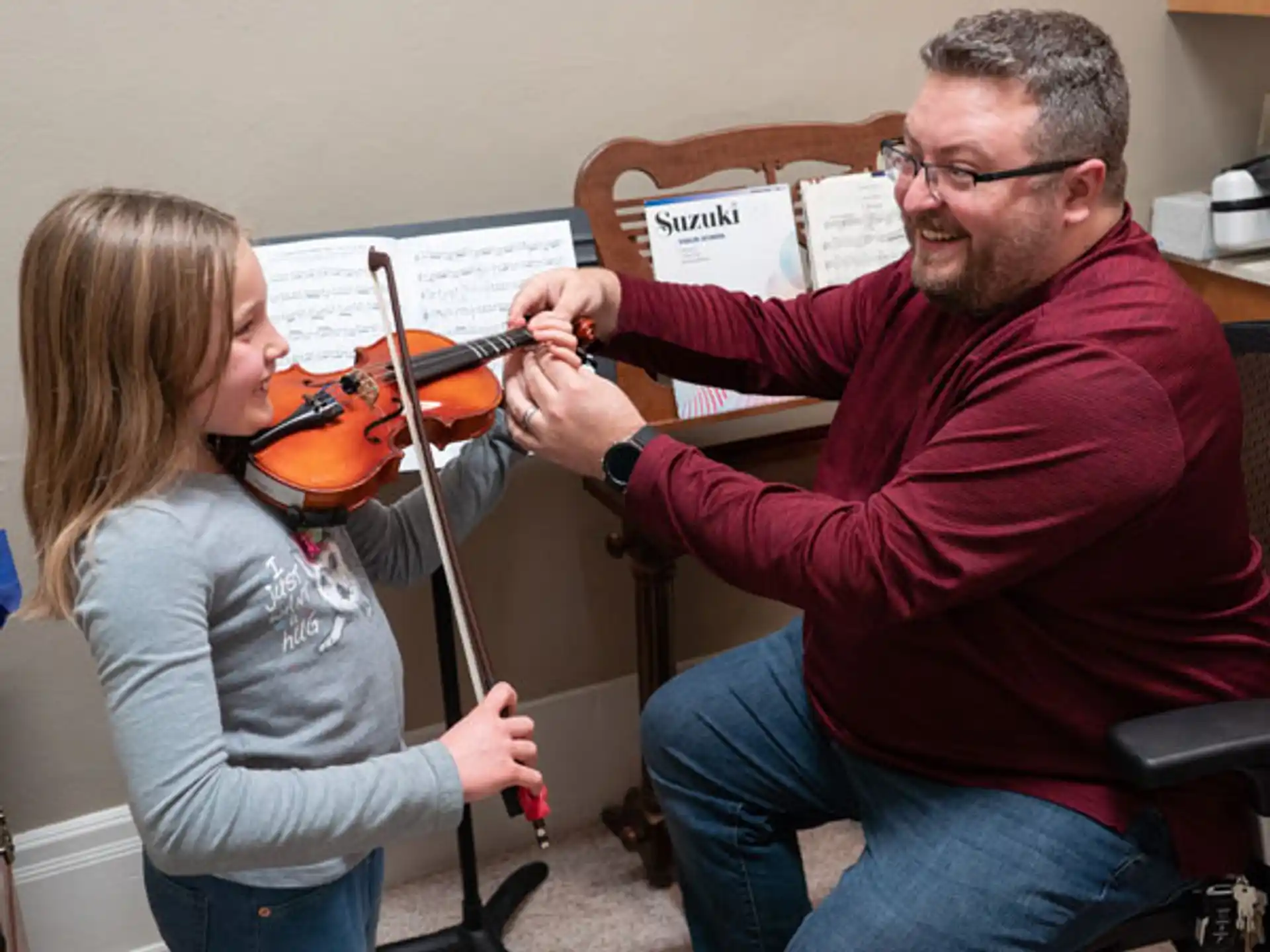 a man playing a violin next to a woman