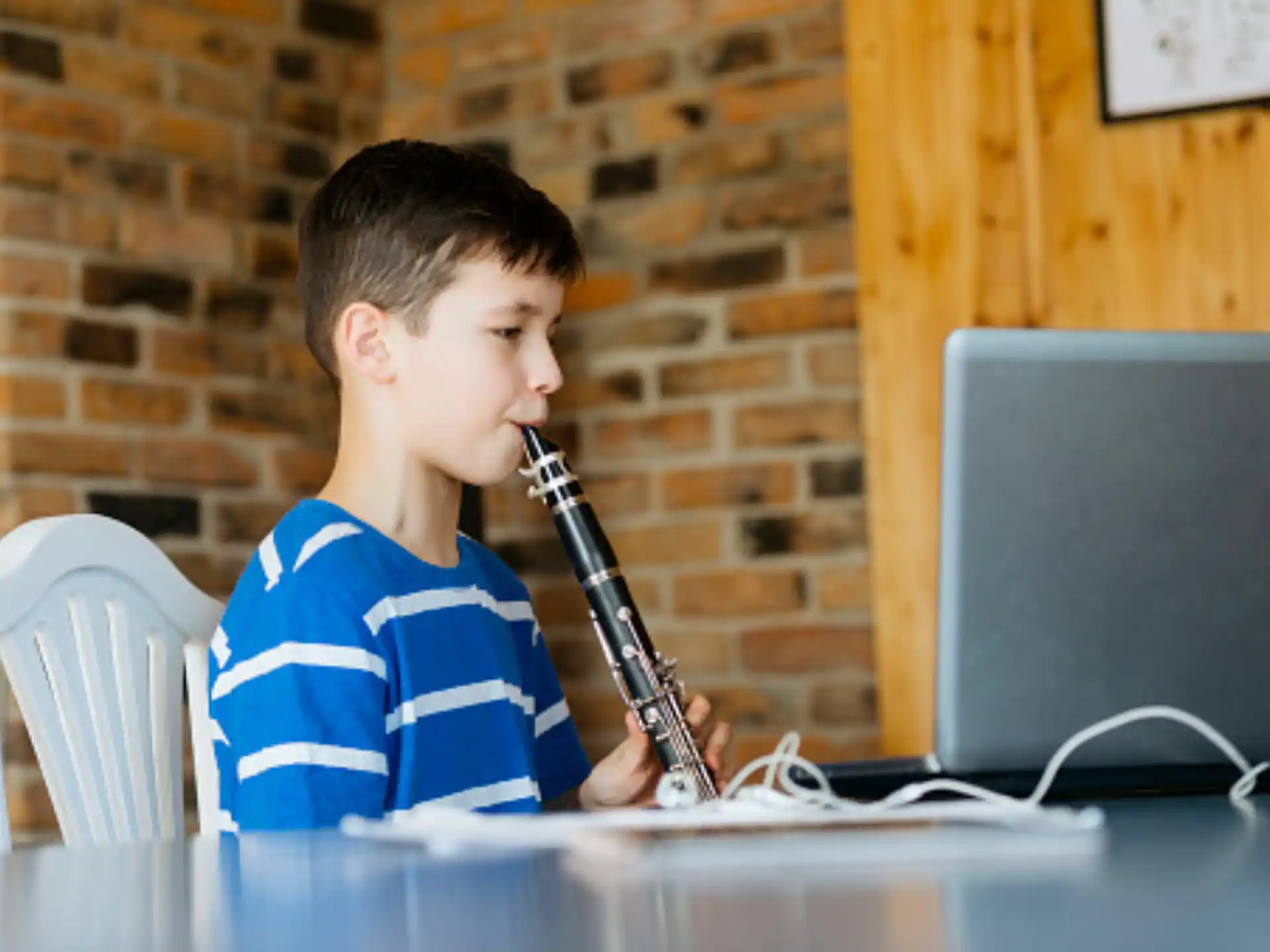 a boy sitting at a desk with a microphone