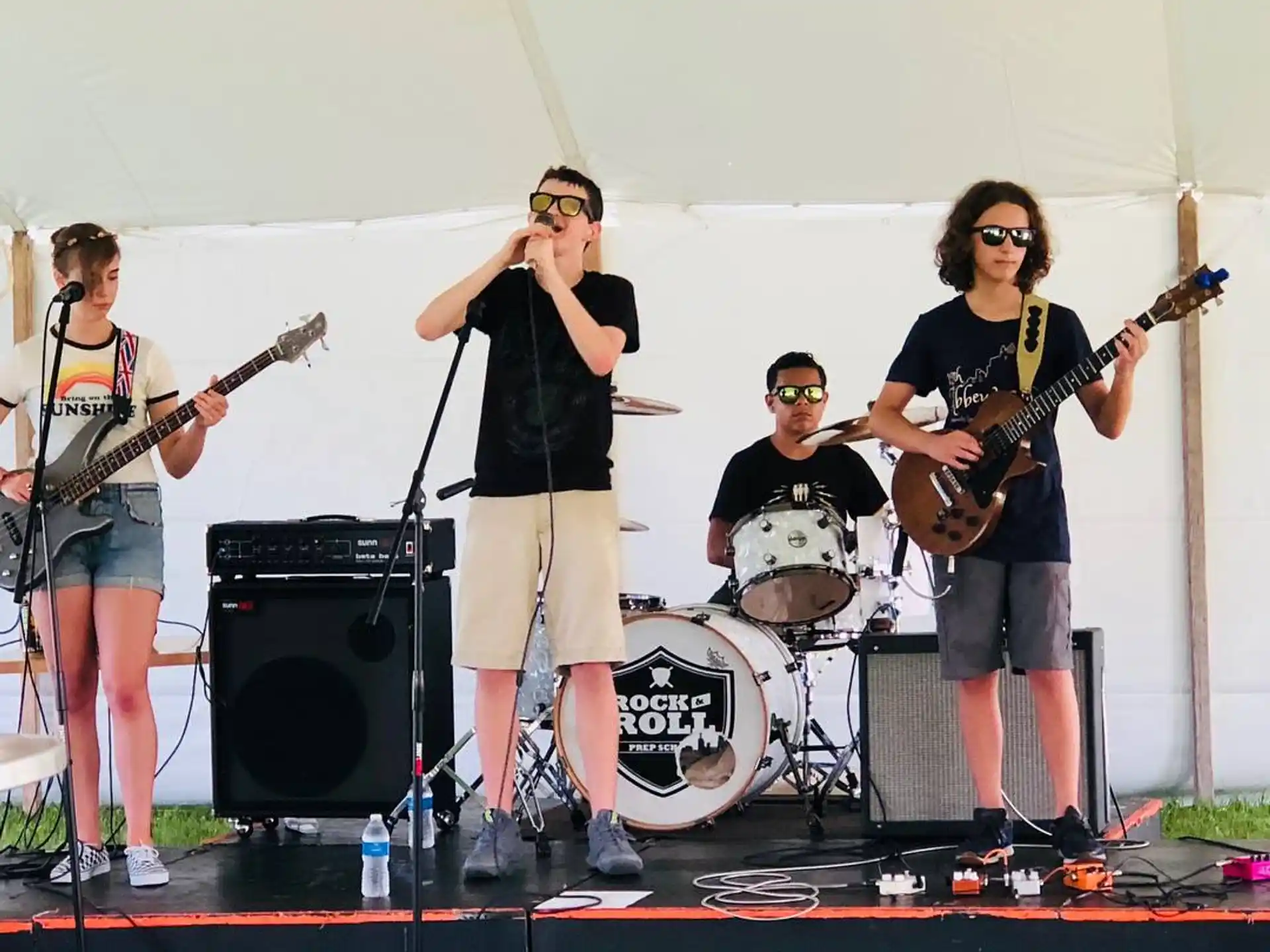 a group of people on a stage with musical instruments