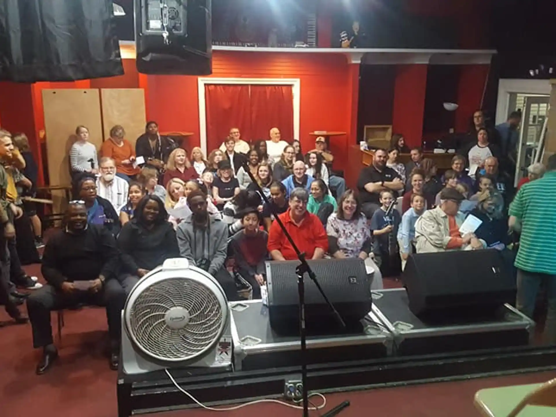 a group of people sitting on a stage