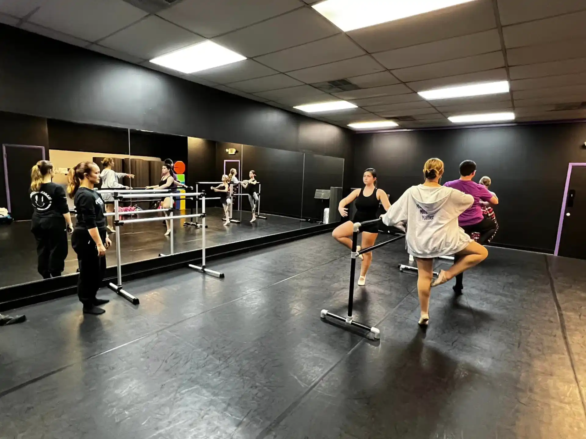 a group of people exercising in a gym