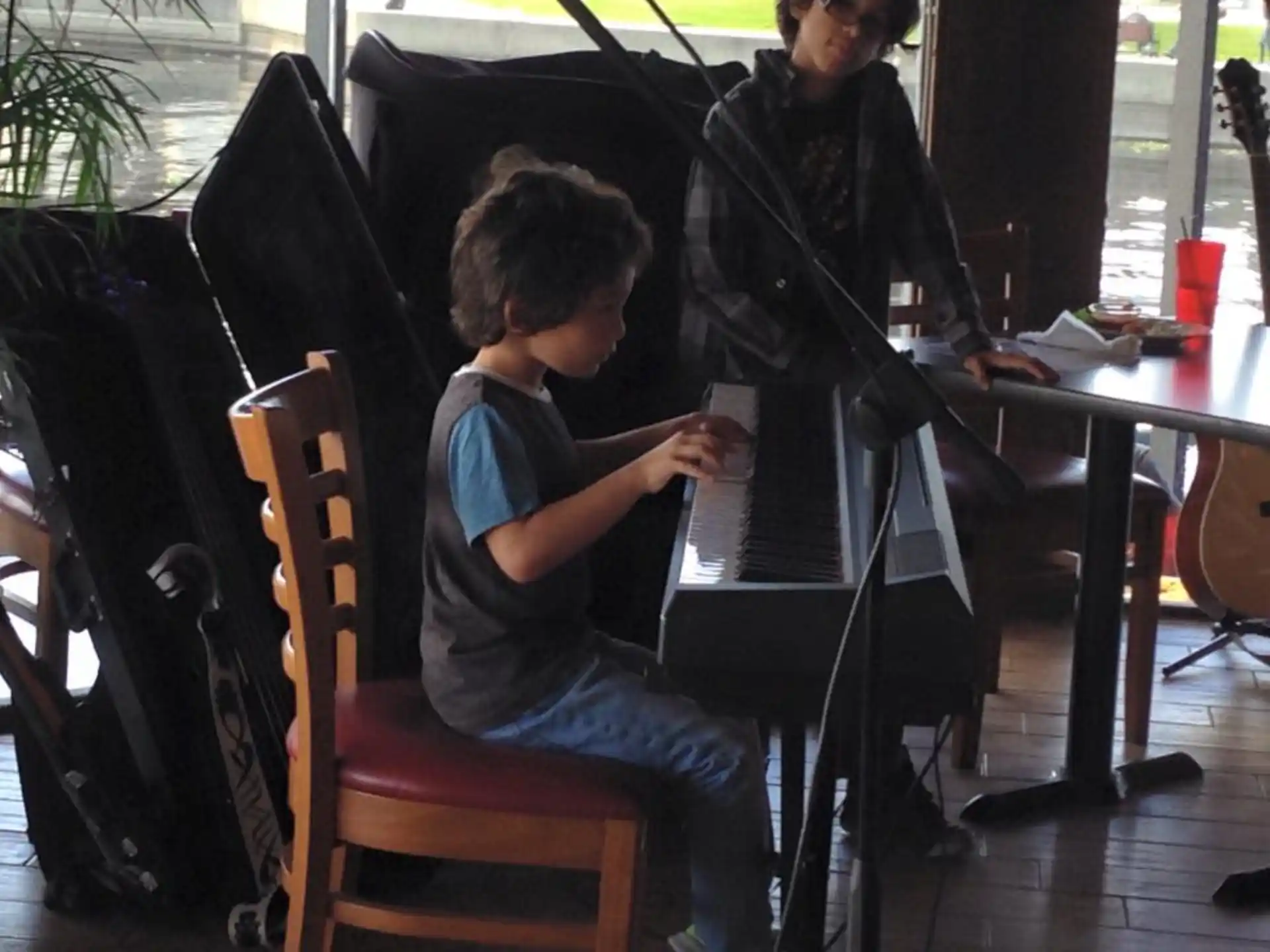 a boy sitting at a desk using a laptop