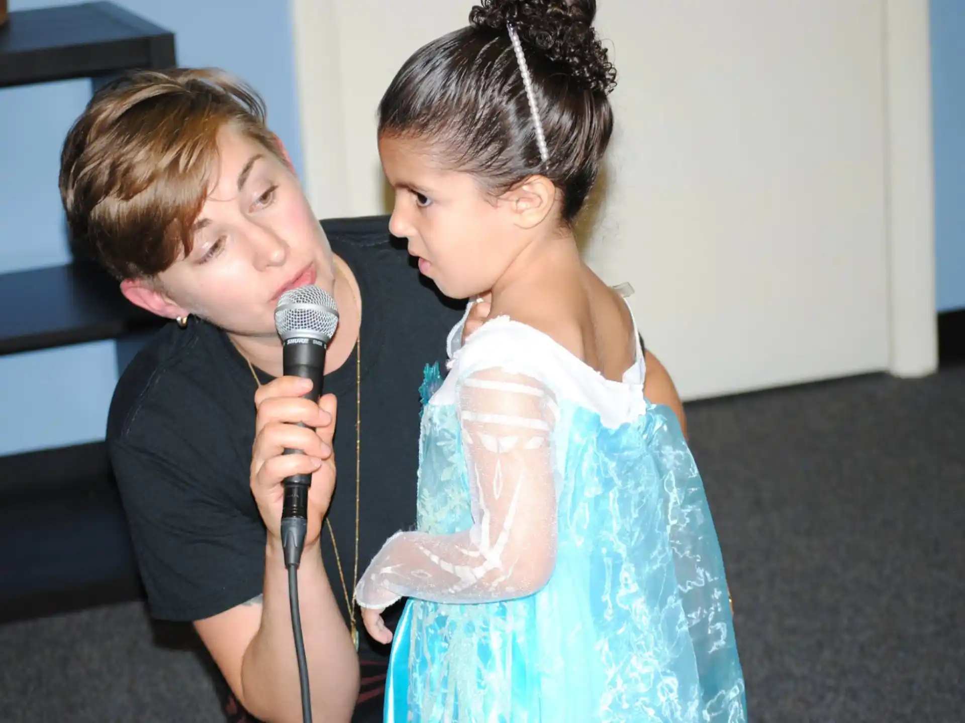 a boy and girl holding a microphone