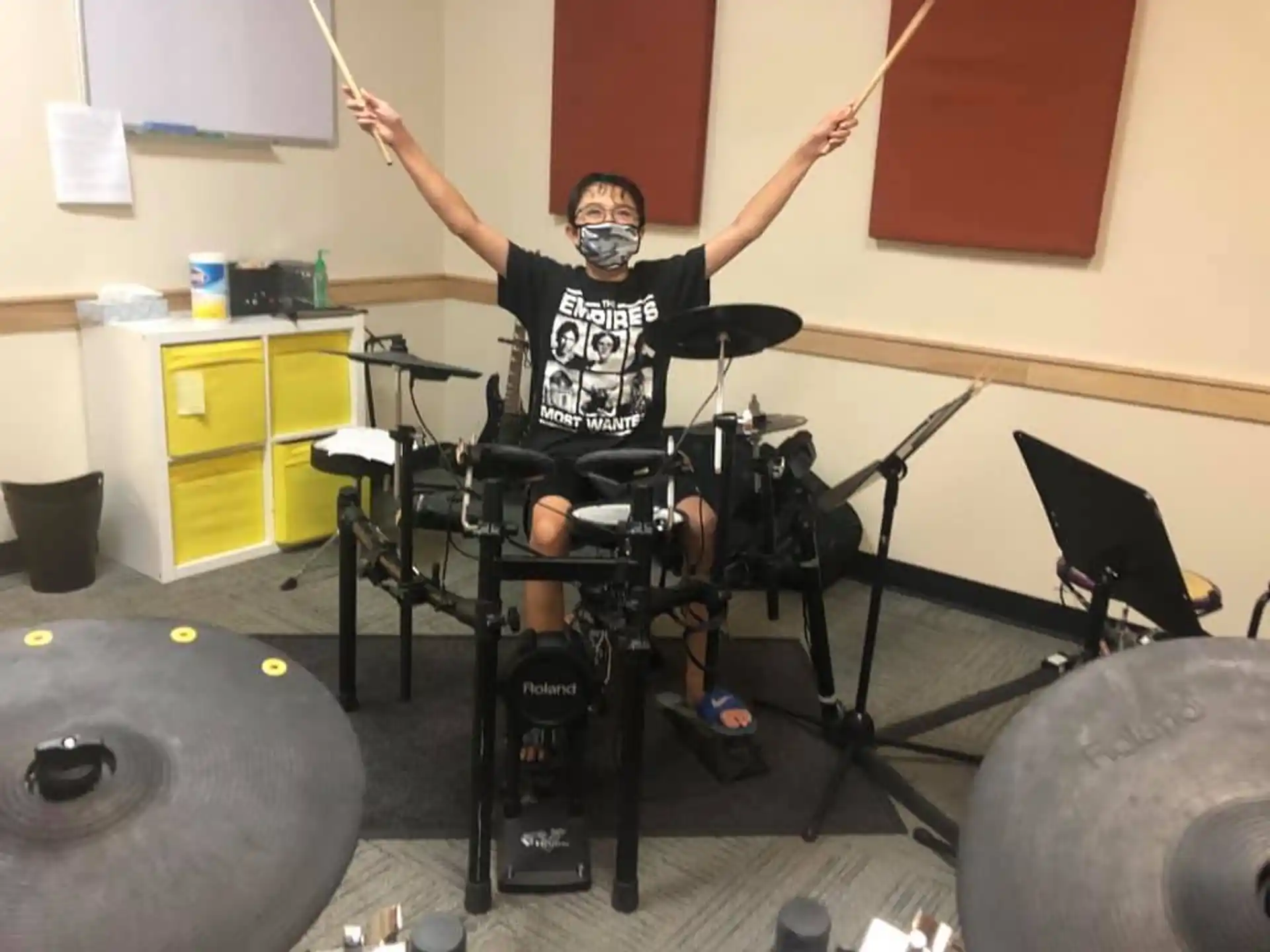 a person sitting on a chair with the arms raised