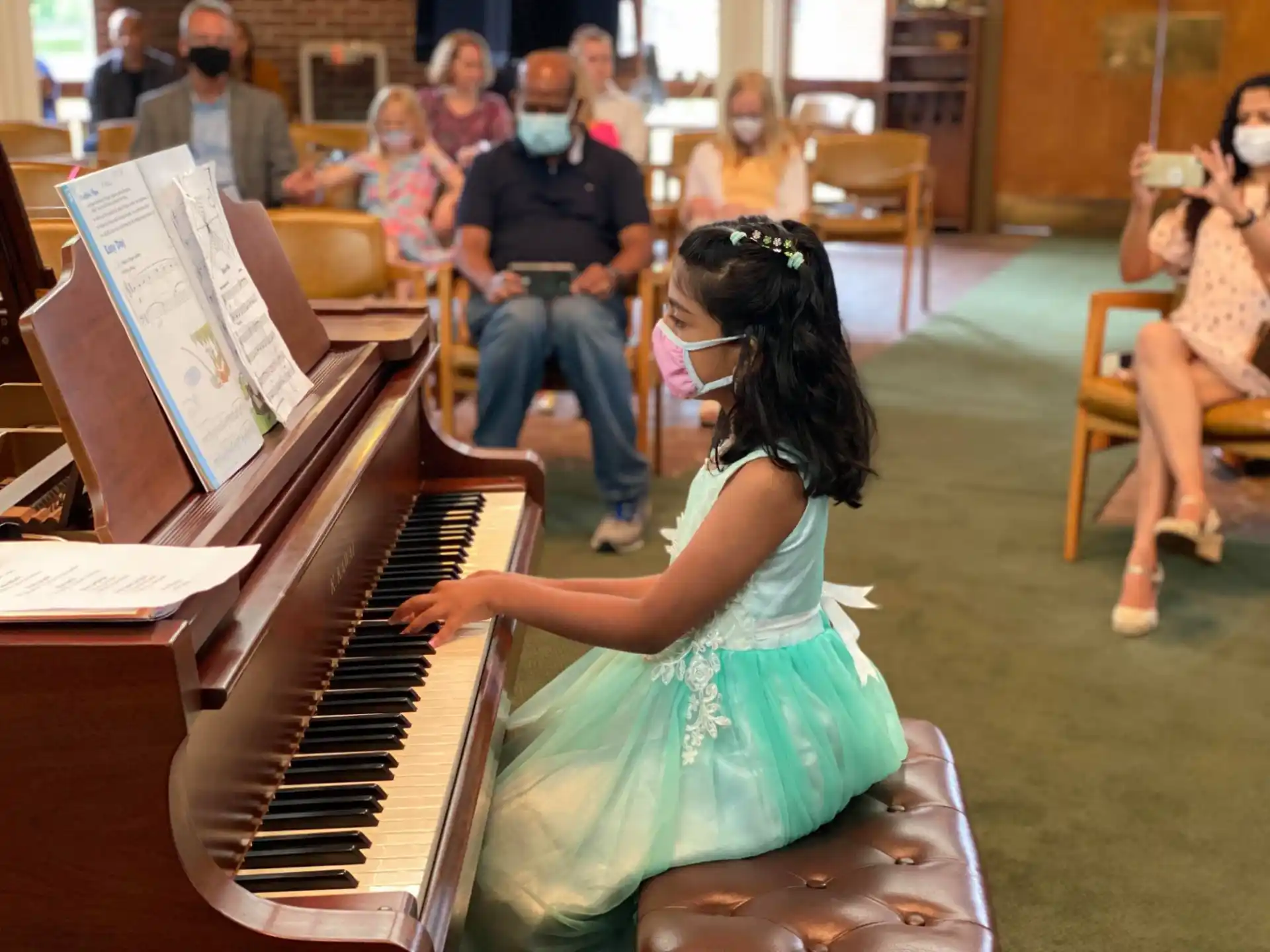 a girl playing a piano