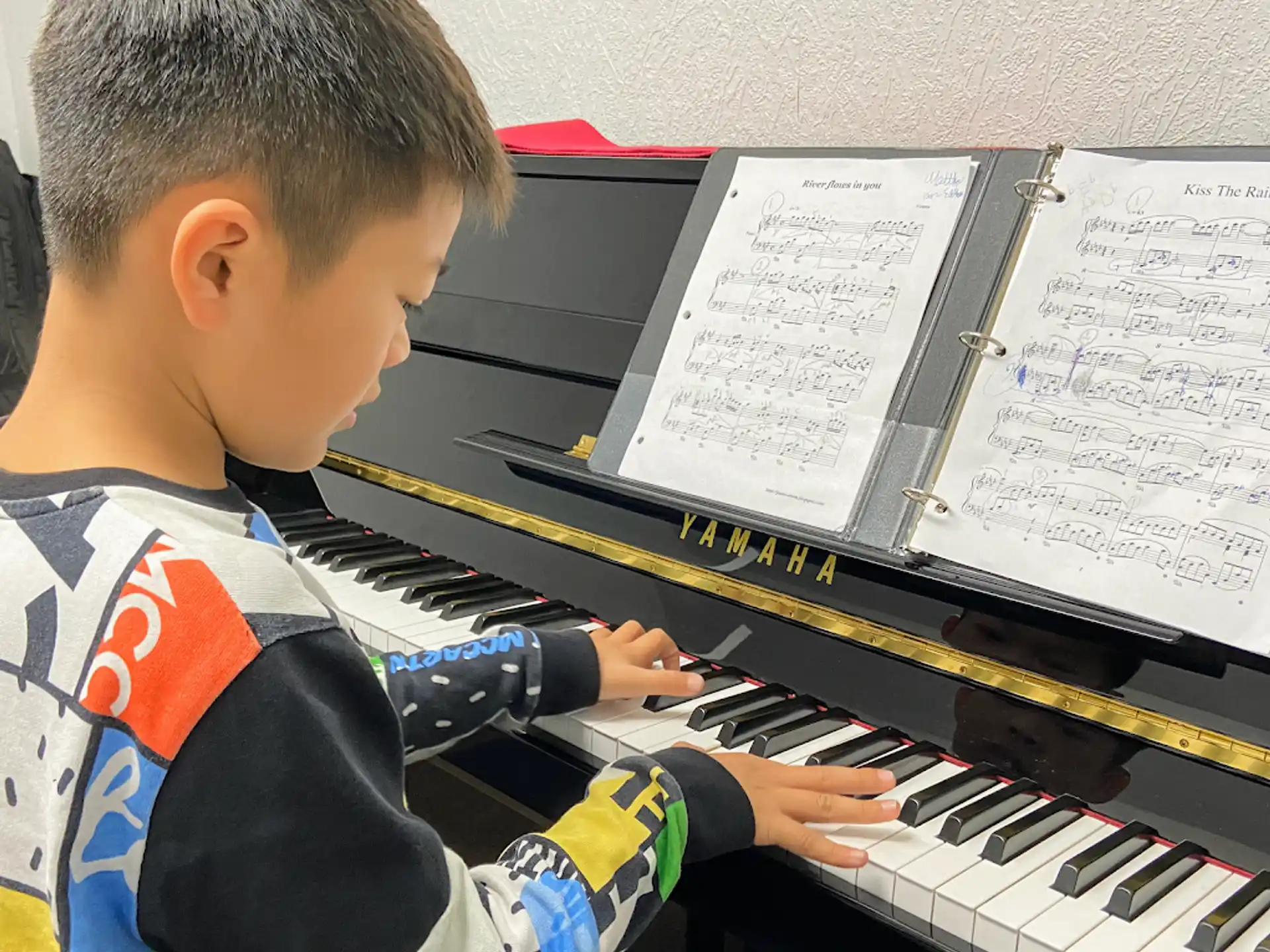a boy playing a piano