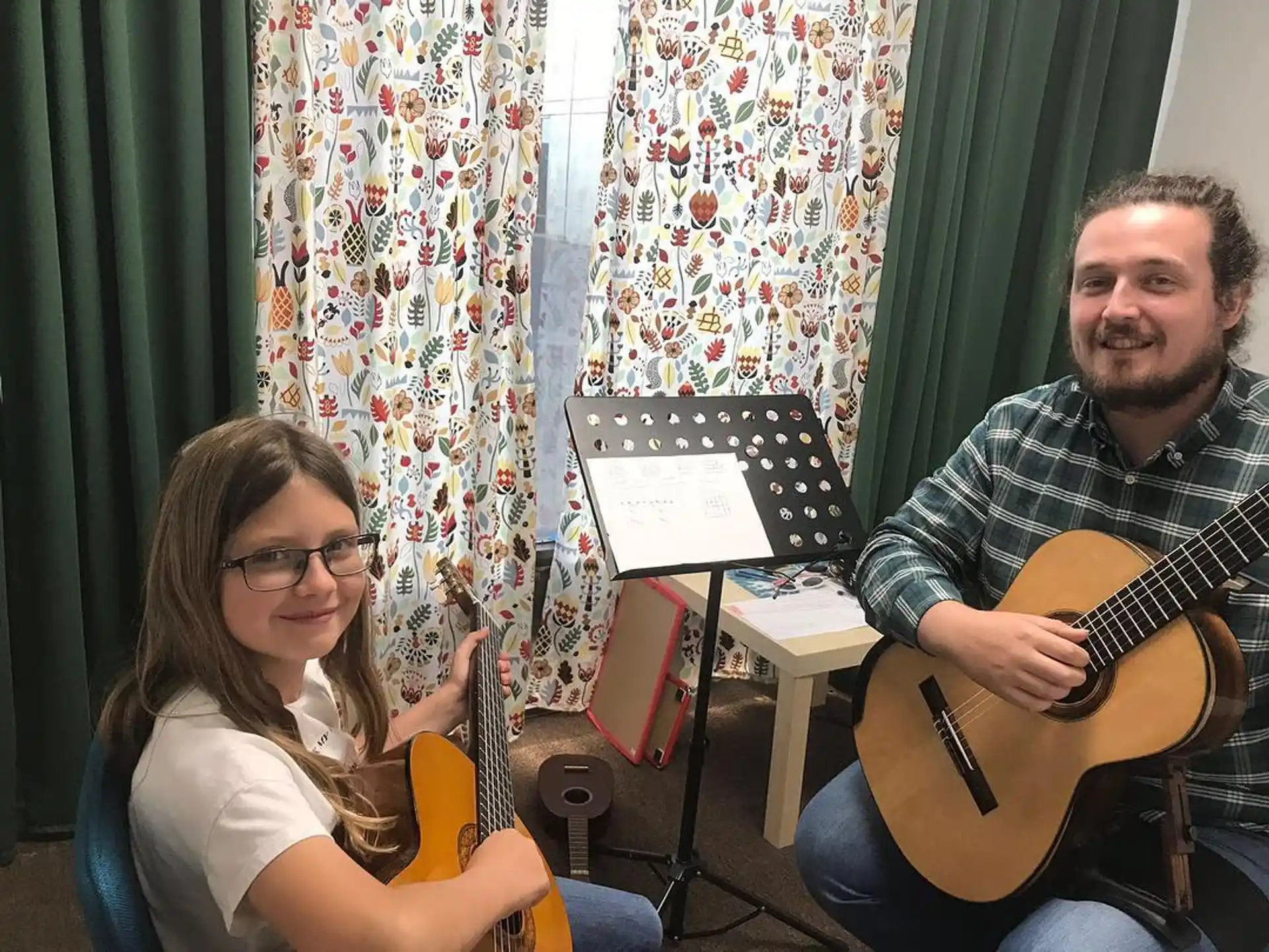 a man and a woman holding guitars