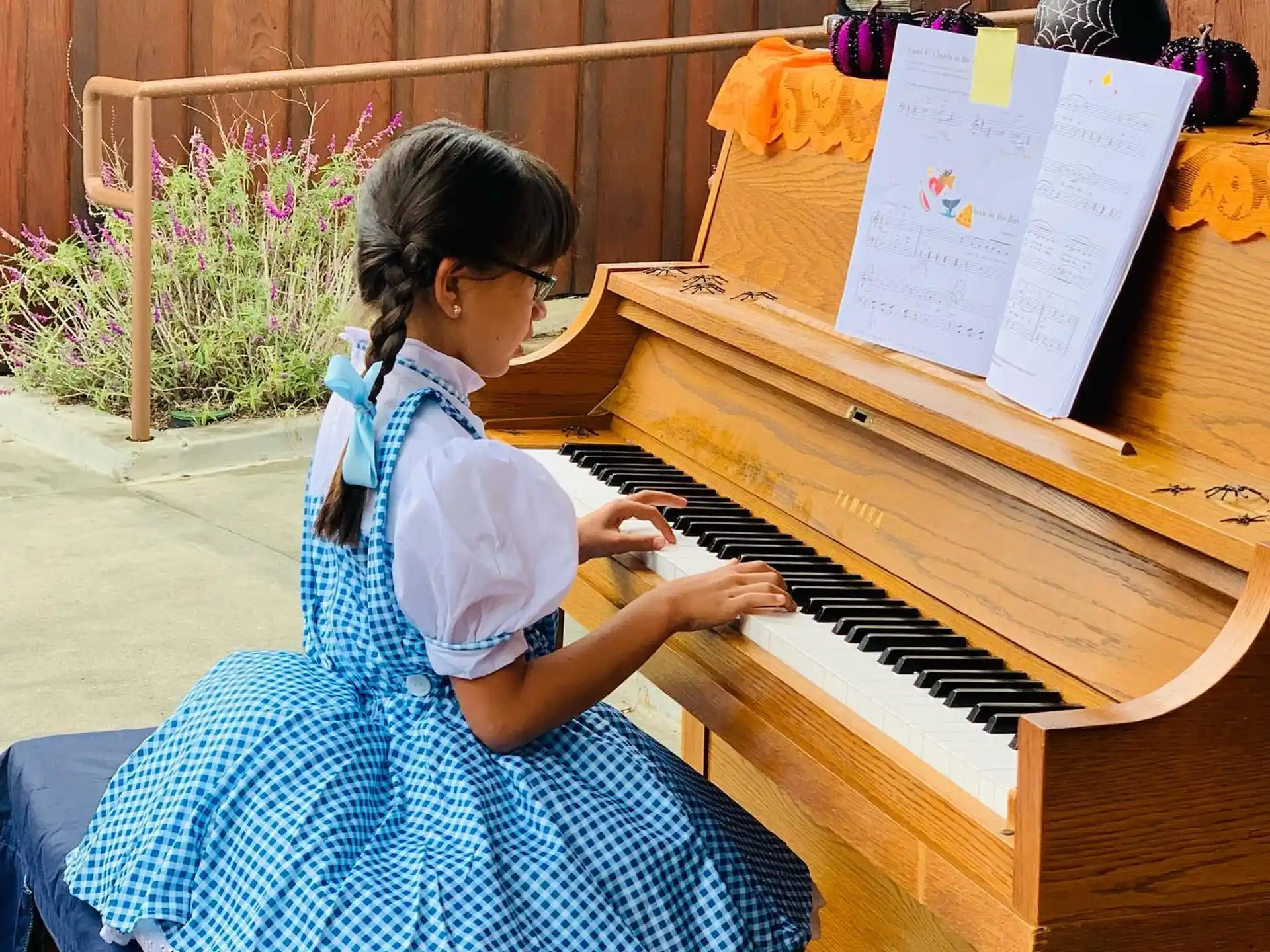 a girl playing a piano