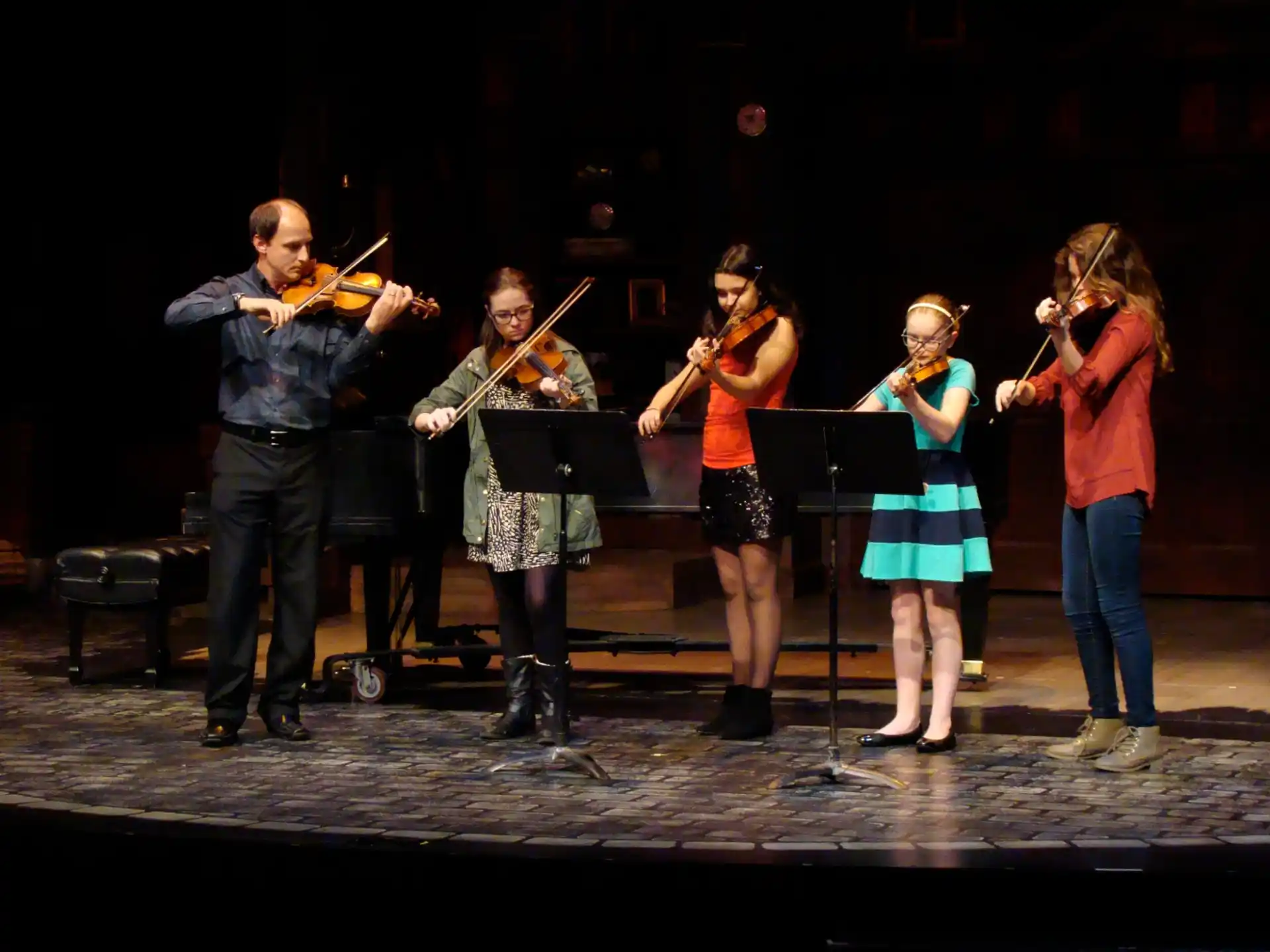 a group of people playing instruments on a stage