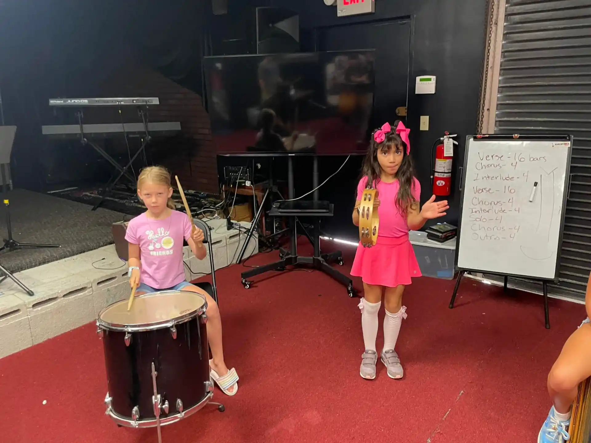 a couple of girls playing drums