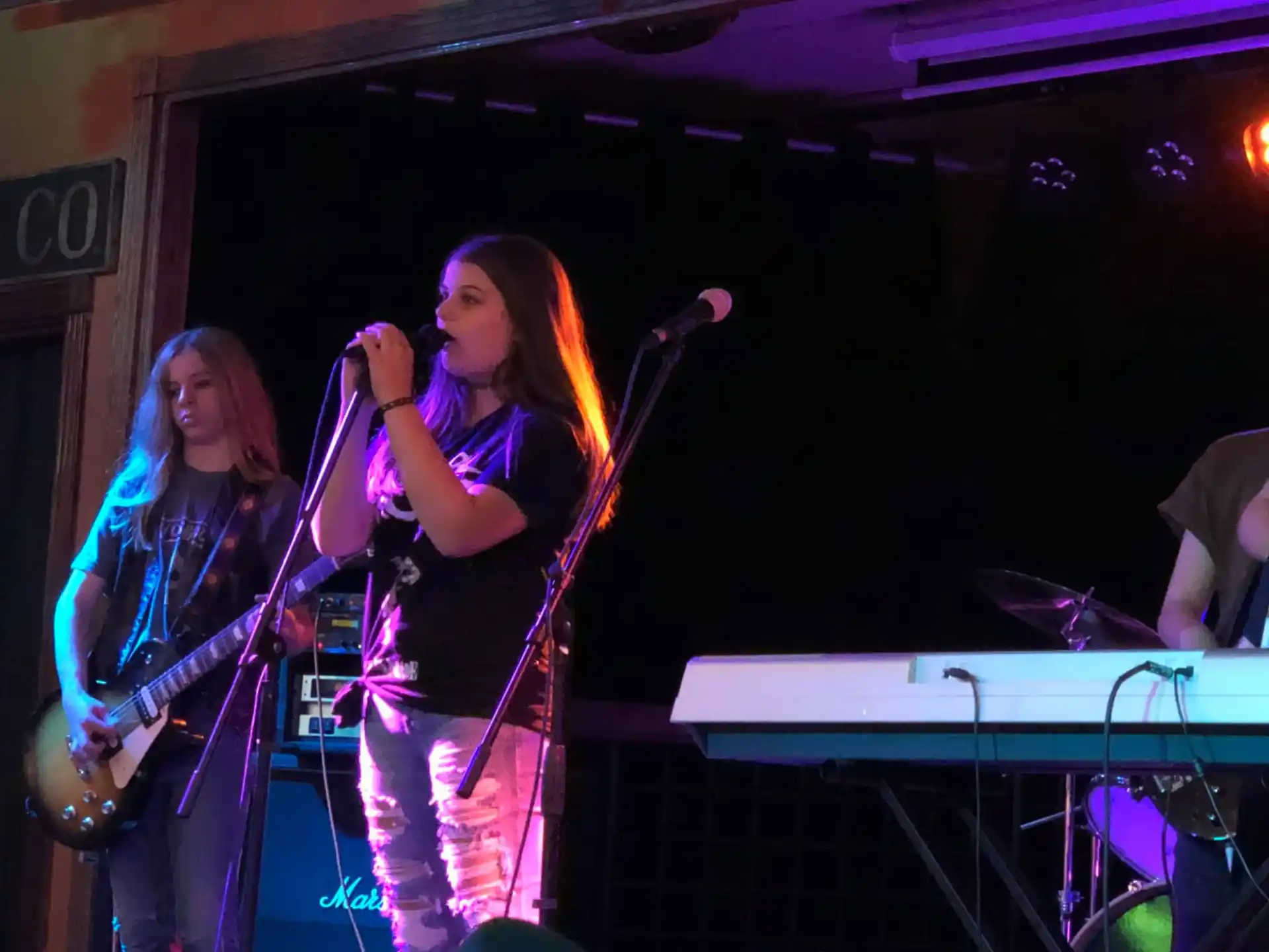 a couple of women singing on stage