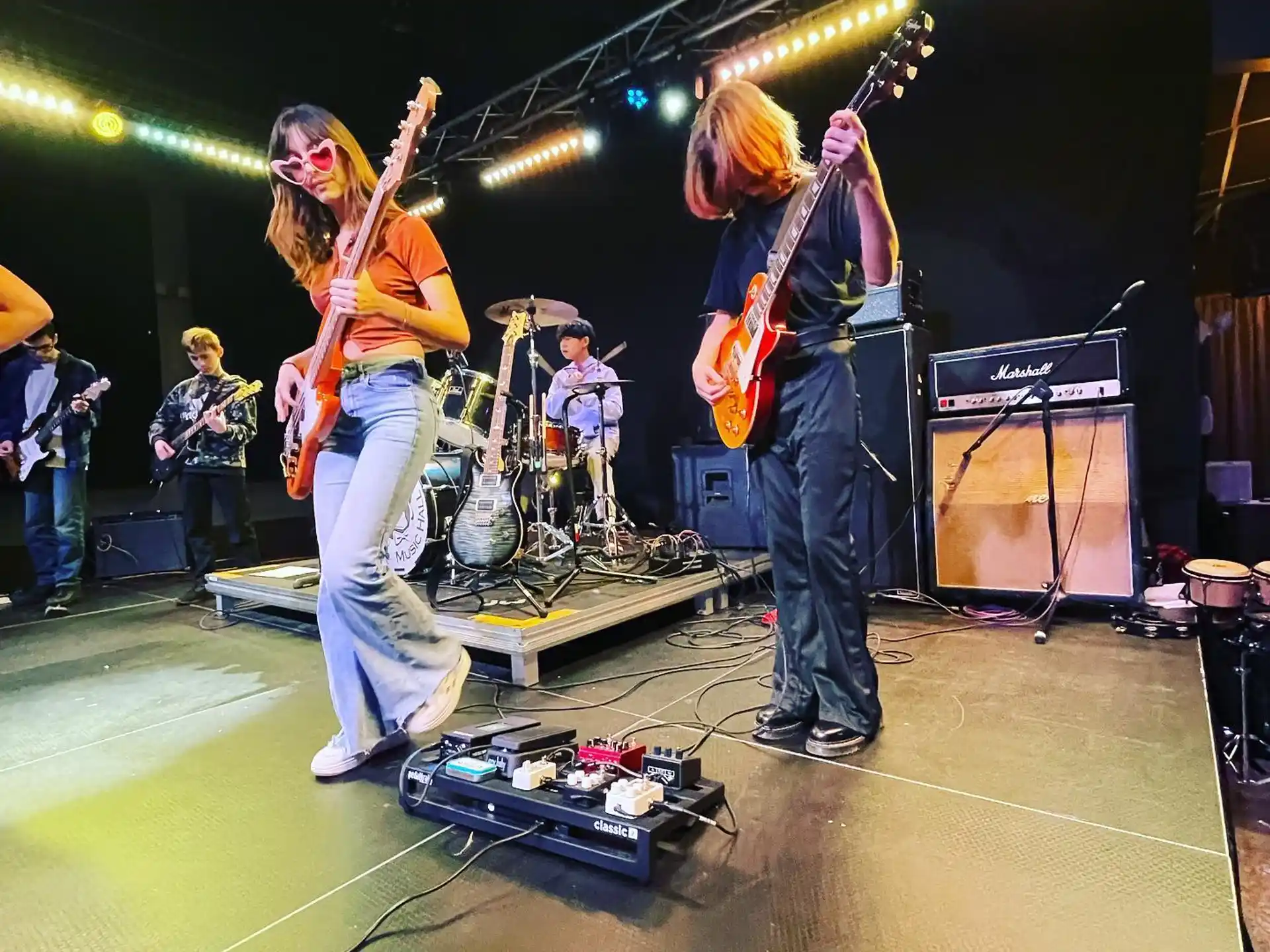 a group of people playing instruments on a stage
